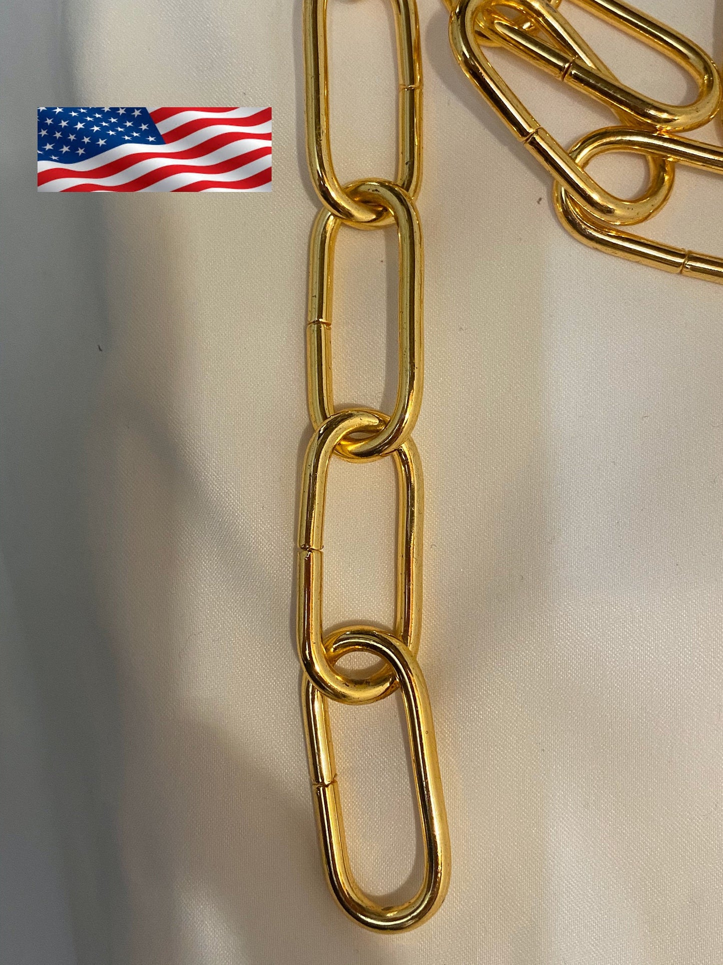 Gold chain on a white background with an American flag icon.