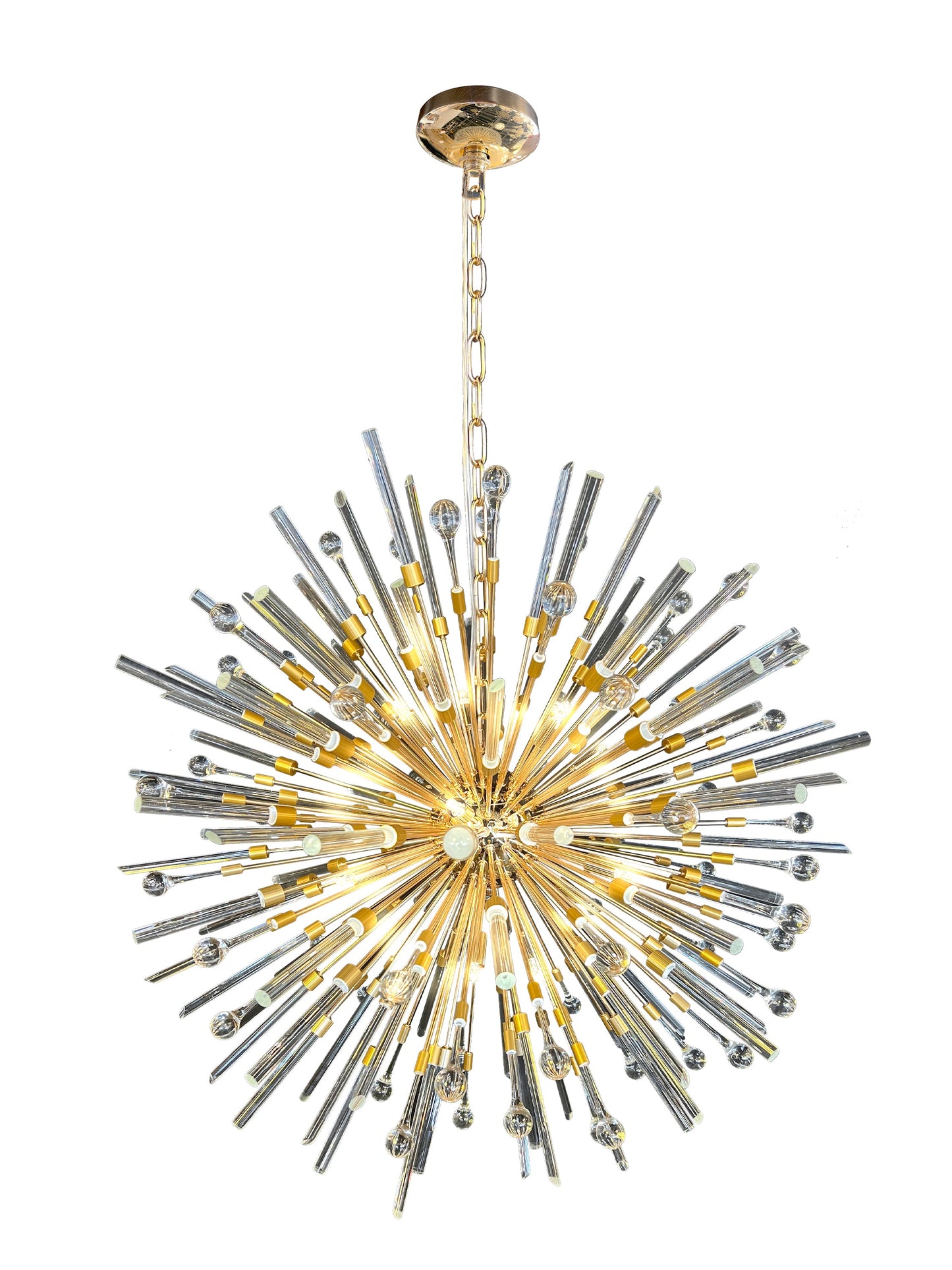 Side view of luxury gold pendant chandelier showcasing warm lighting.