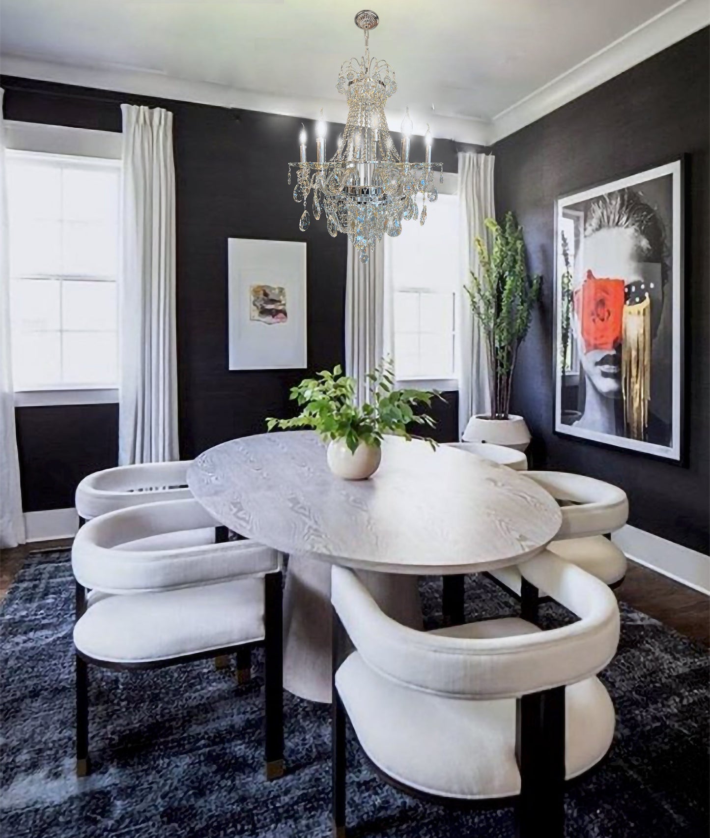 Elegant chrome  crystal chandelier above classic dining table with modern wall paneling.