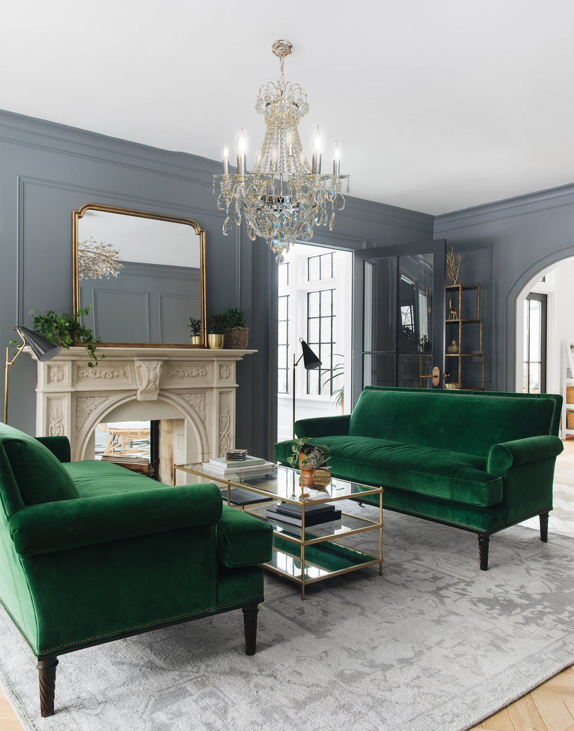 polished chrome  crystal chandelier illuminating classic living room interior with green sofa.