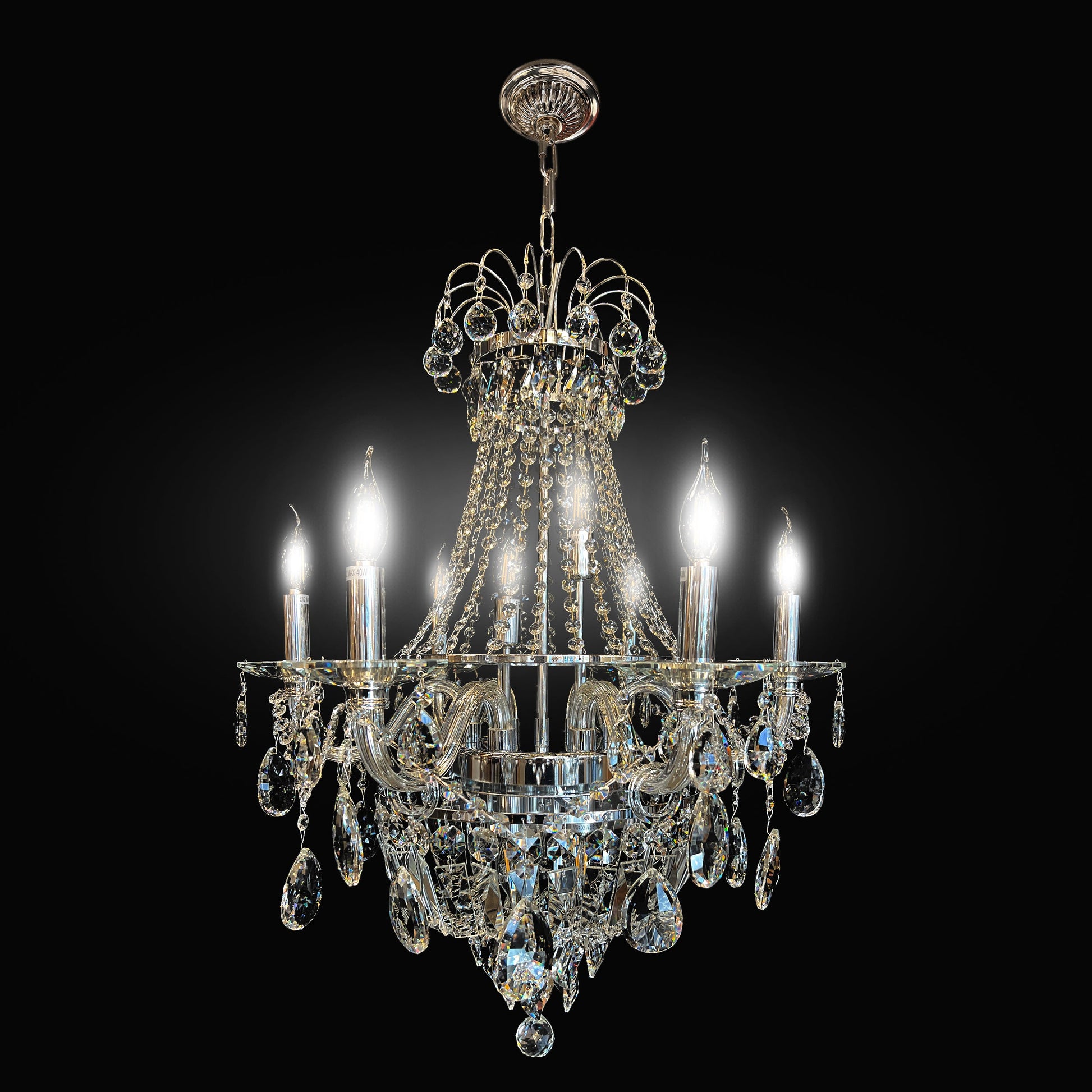 A luxurious vintage crystal chandelier with a chrome finish, featuring many precision-cut crystals and eight light bulbs, designed to provide brilliance and sparkle.