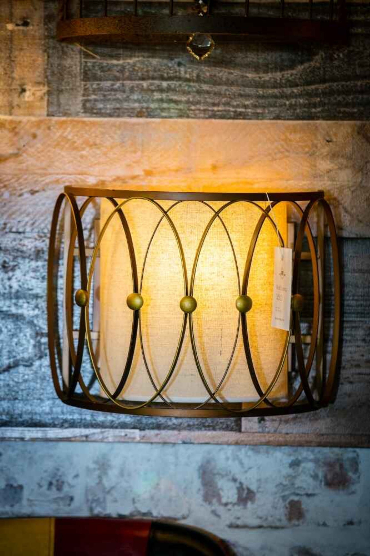 Side angle bronze wall sconce with cage frame
