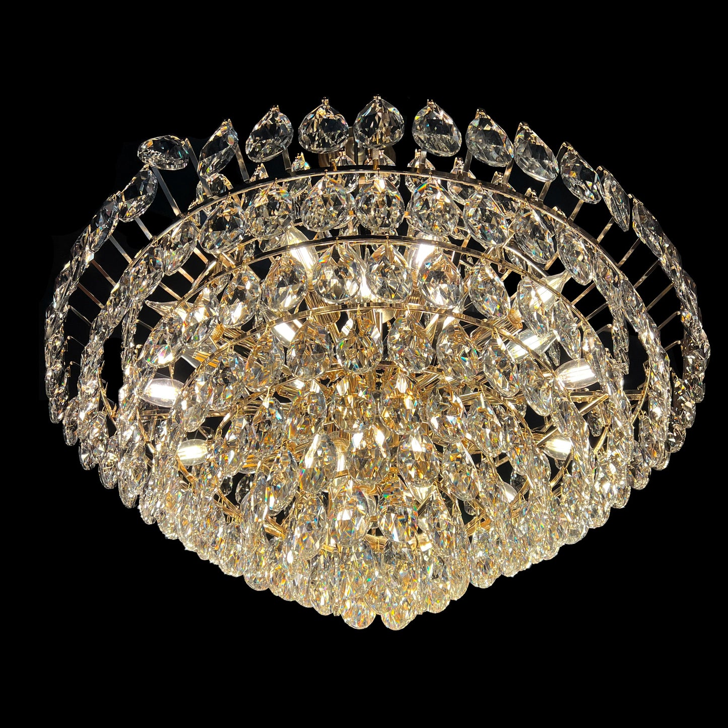 Close-up of 31 inch champagne gold crystal chandelier with teardrop crystals and empire-style design.