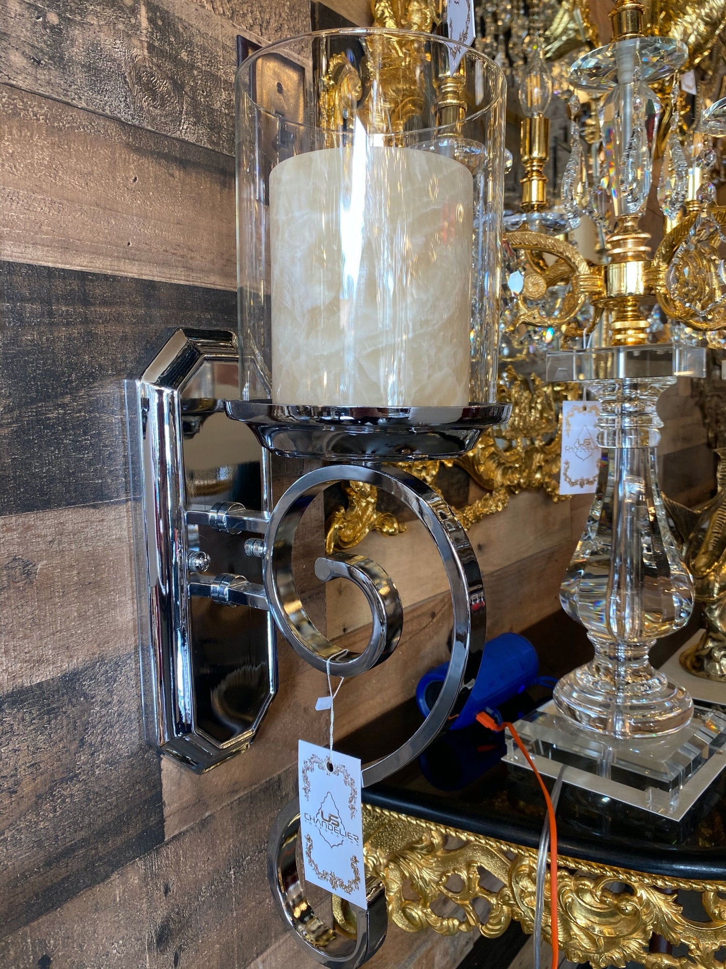 Close-up curved chrome frame wall sconce design