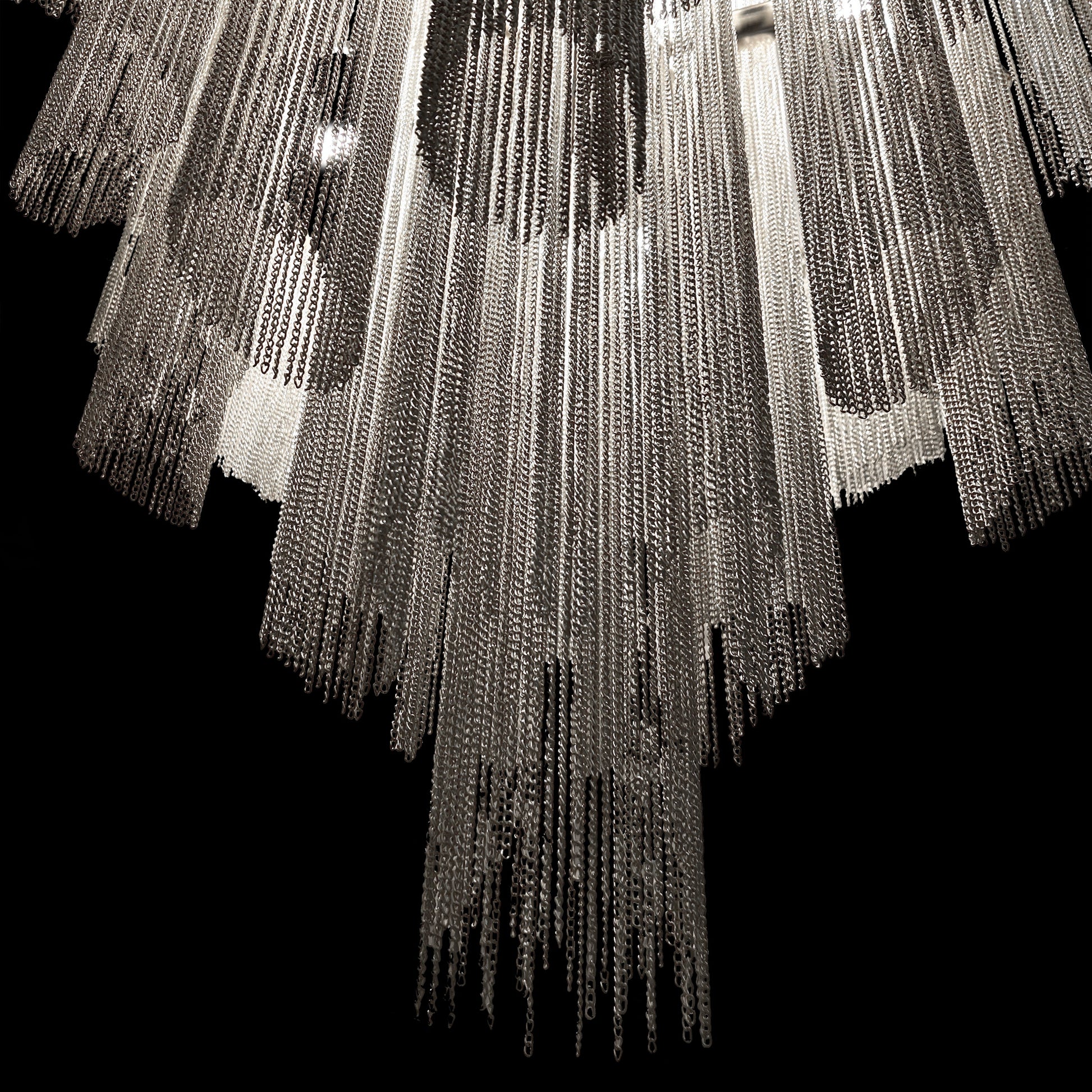Close-up view showing the polished chrome finish and cascading metallic chains of the luxury waterfall chandelier.
