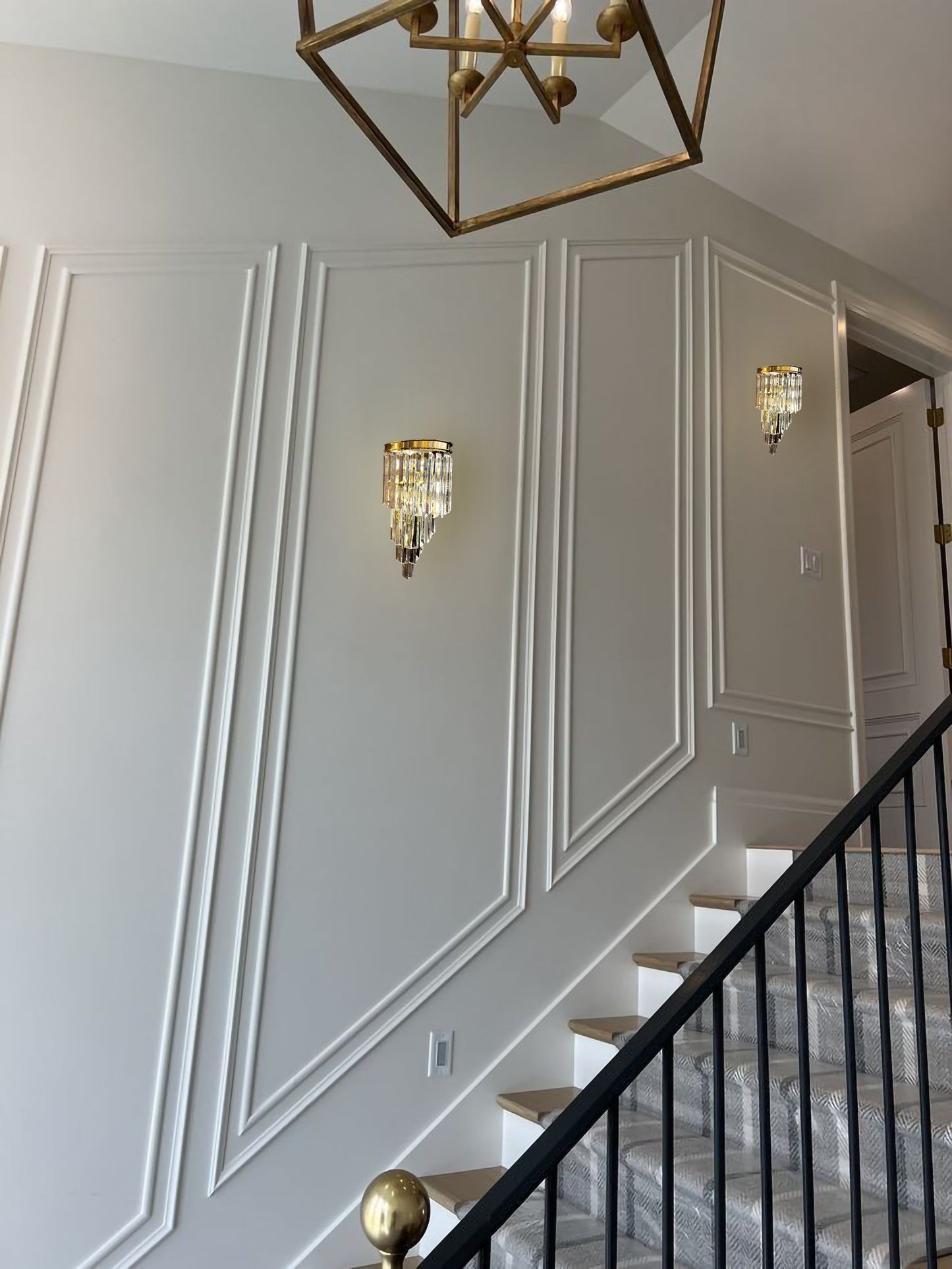 Modern crystal LED wall sconce installed in staircase hallway