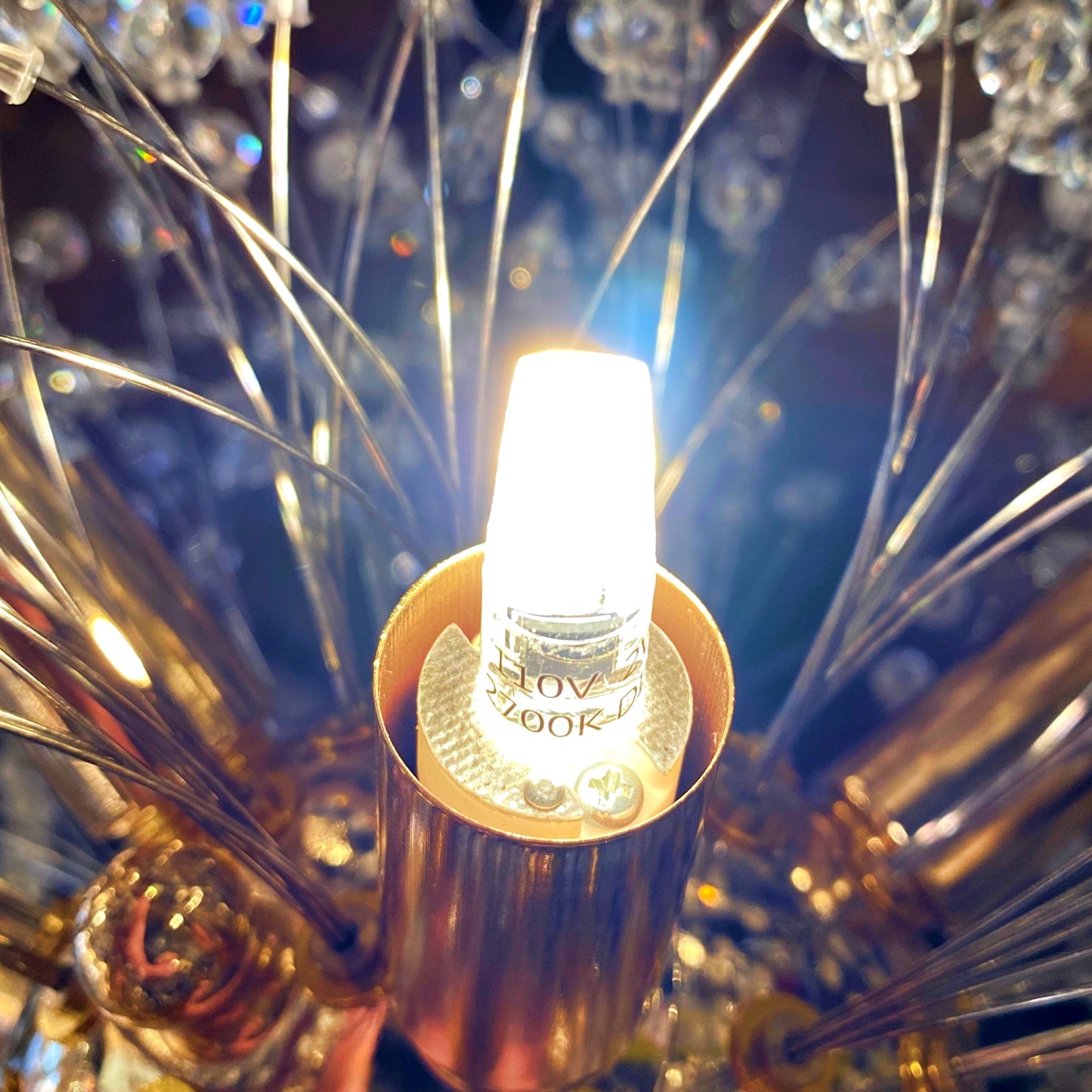 G4 LED bulb installed in chandelier warm glow