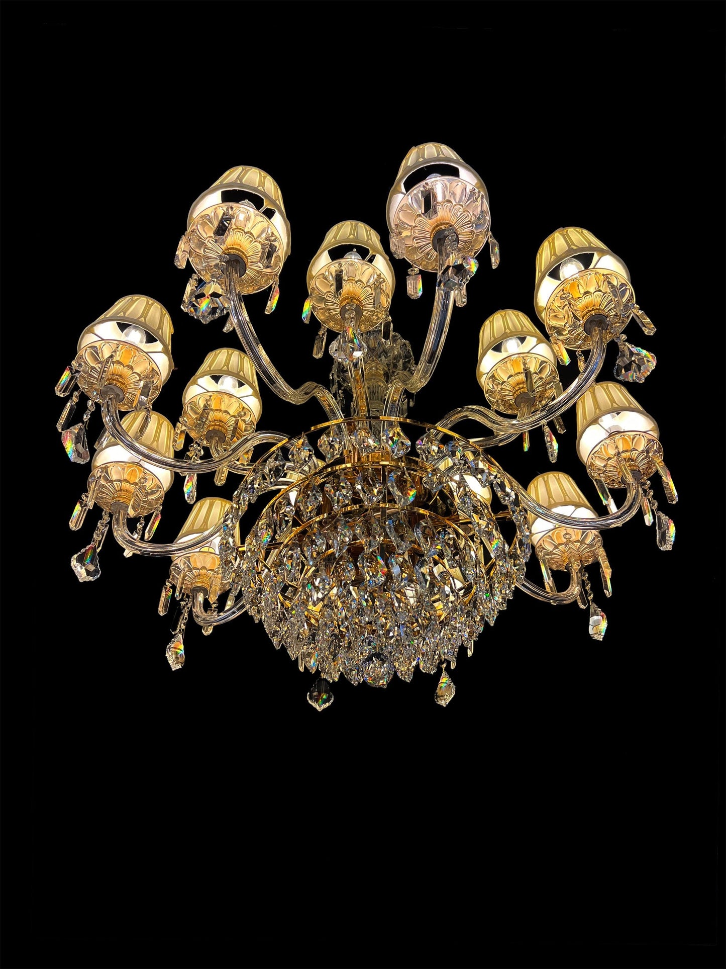 Detailed view of ornate gold arms and hanging crystals on a luxury chandelier