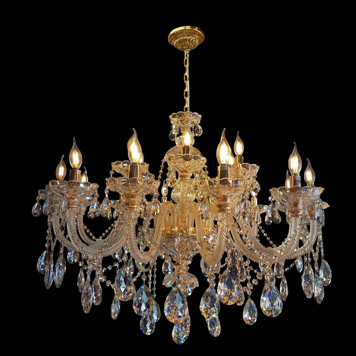 A luxurious gold crystal chandelier with teardrop accents and curved glass arms, designed for elegant indoor lighting.