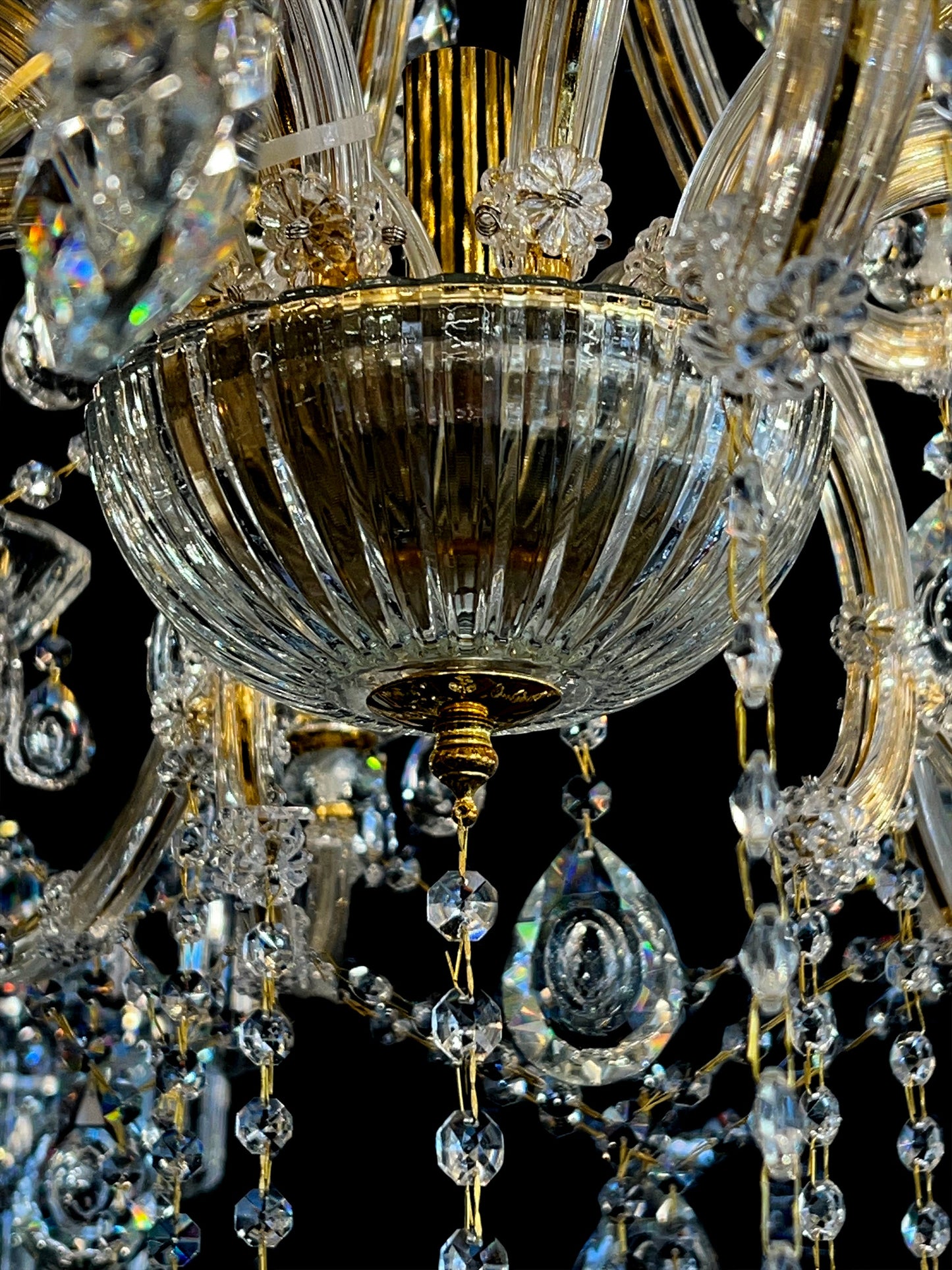 Gold arm and crystal teardrop detailing on 45-inch chandelier