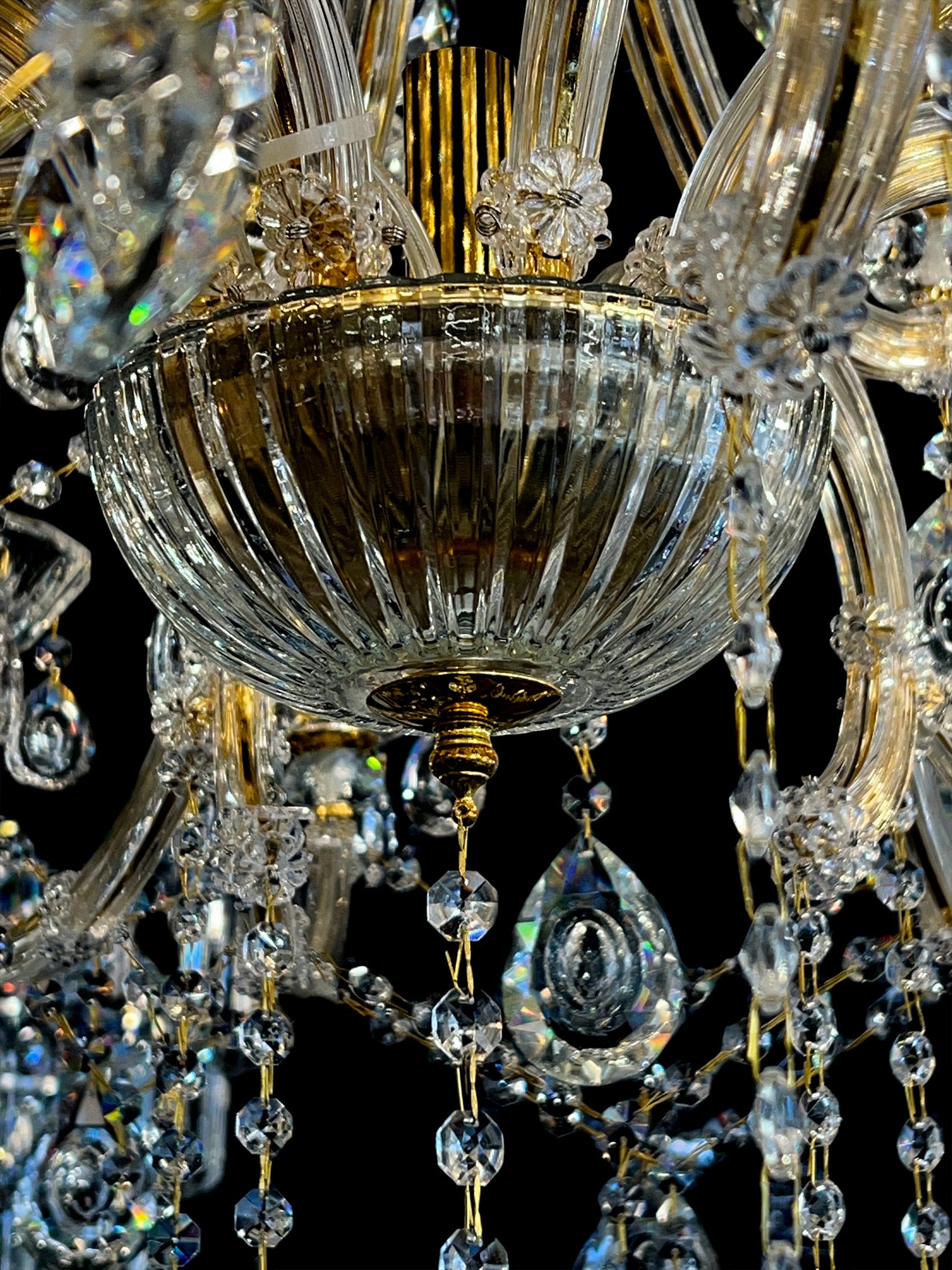 Gold arm and crystal teardrop detailing on 45-inch chandelier