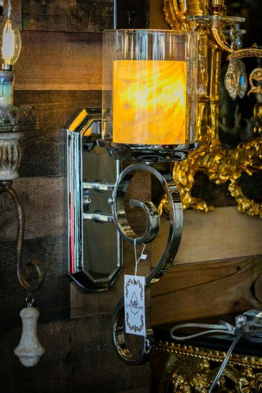 Side view chrome wall sconce with curved frame and glass shade