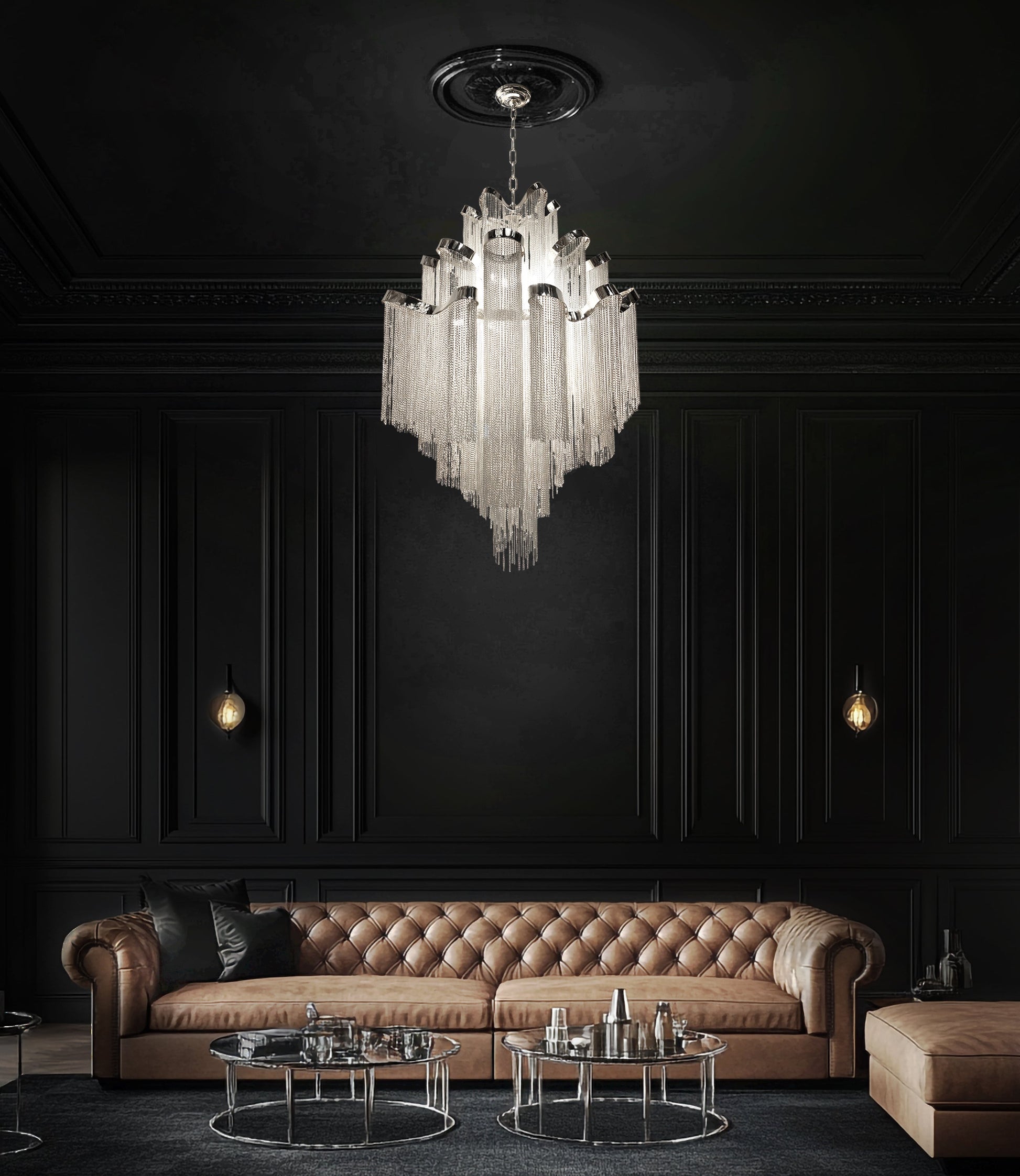 Luxury chrome waterfall chandelier suspended above a brown leather sofa in a designer modern living space.
