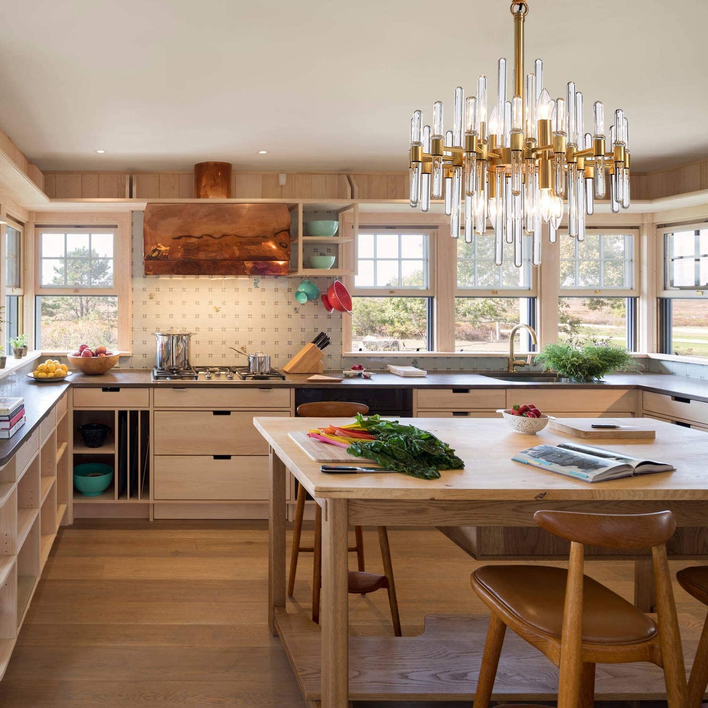Luxury glass rod chandelier hanging over spacious kitchen island
