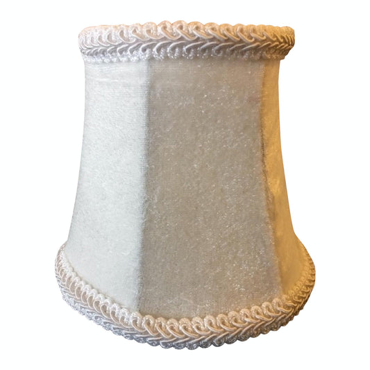 A handmade white velvet lamp shade with a clip-on design and elegant braided trim detailing.