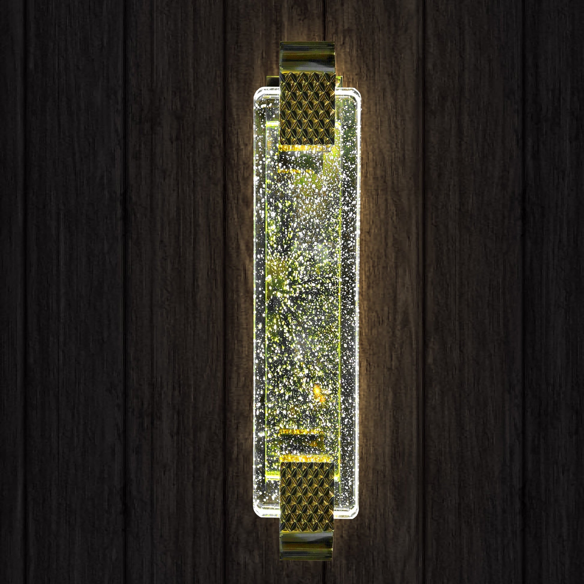 Decorative wall sconce with sparkling design on a wooden background