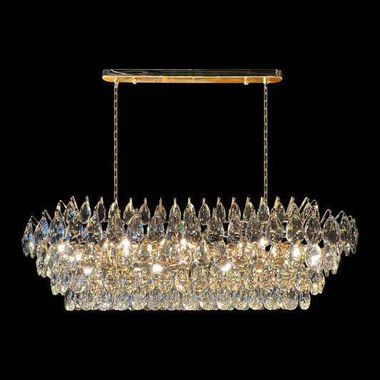 Champagne gold rectangular crystal chandelier with teardrop K9 crystals and empire-style linear design on a black background.