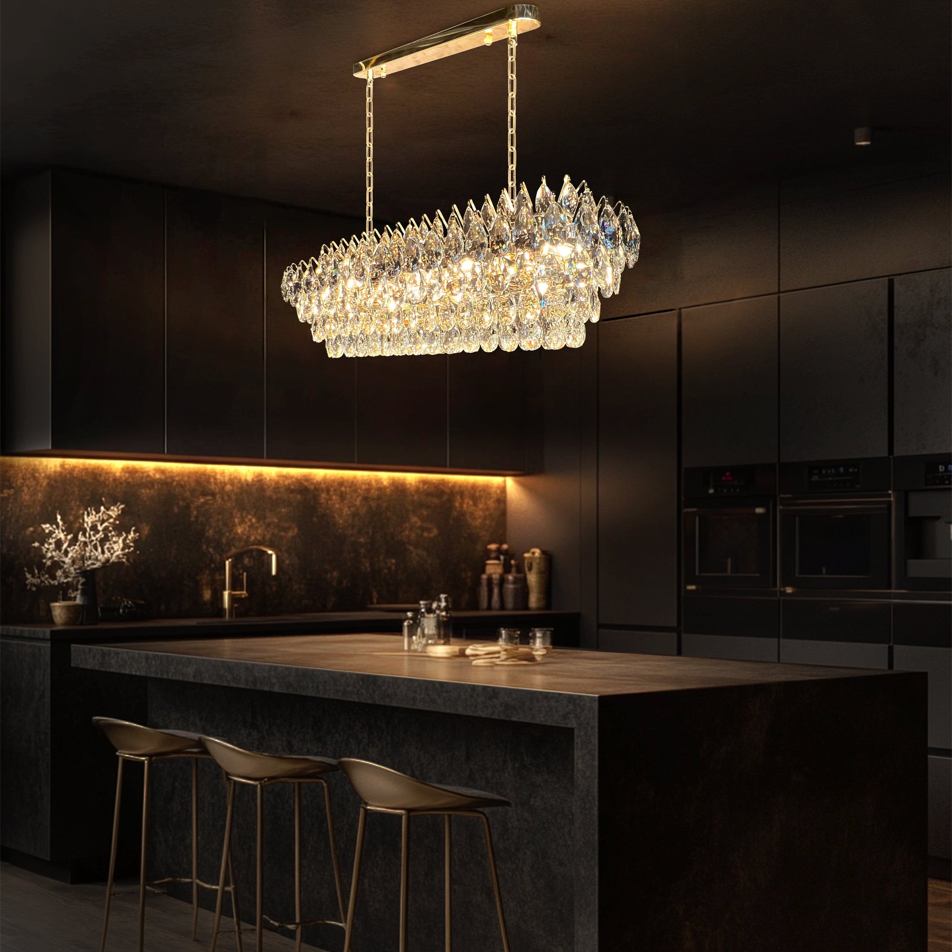 Champagne gold rectangular crystal chandelier with teardrop K9 crystals and a polished linear empire-style design illuminated in warm light.