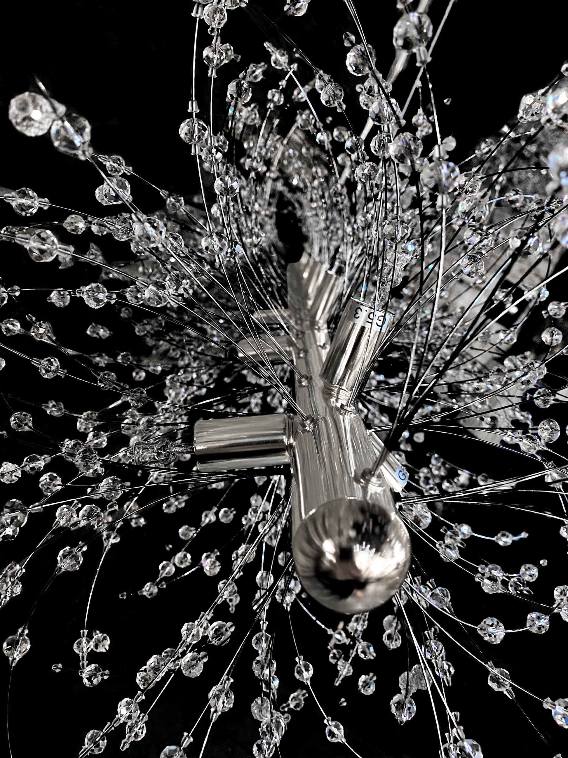 Faceted crystal details reflecting light on chrome frame