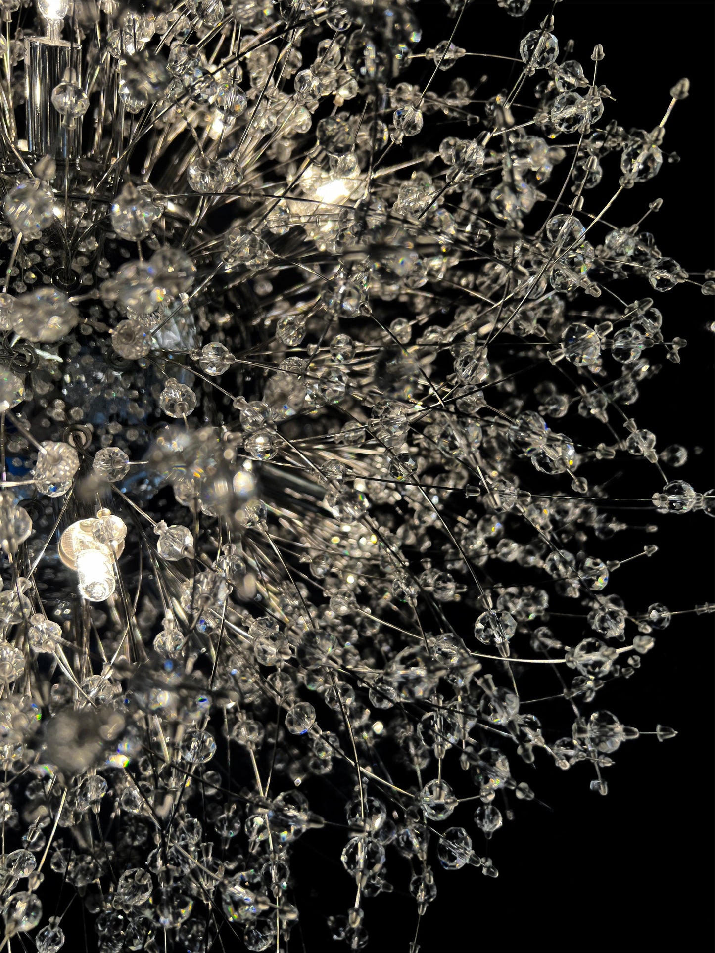  Detailed close-up of chrome starburst chandelier with sparkling crystals