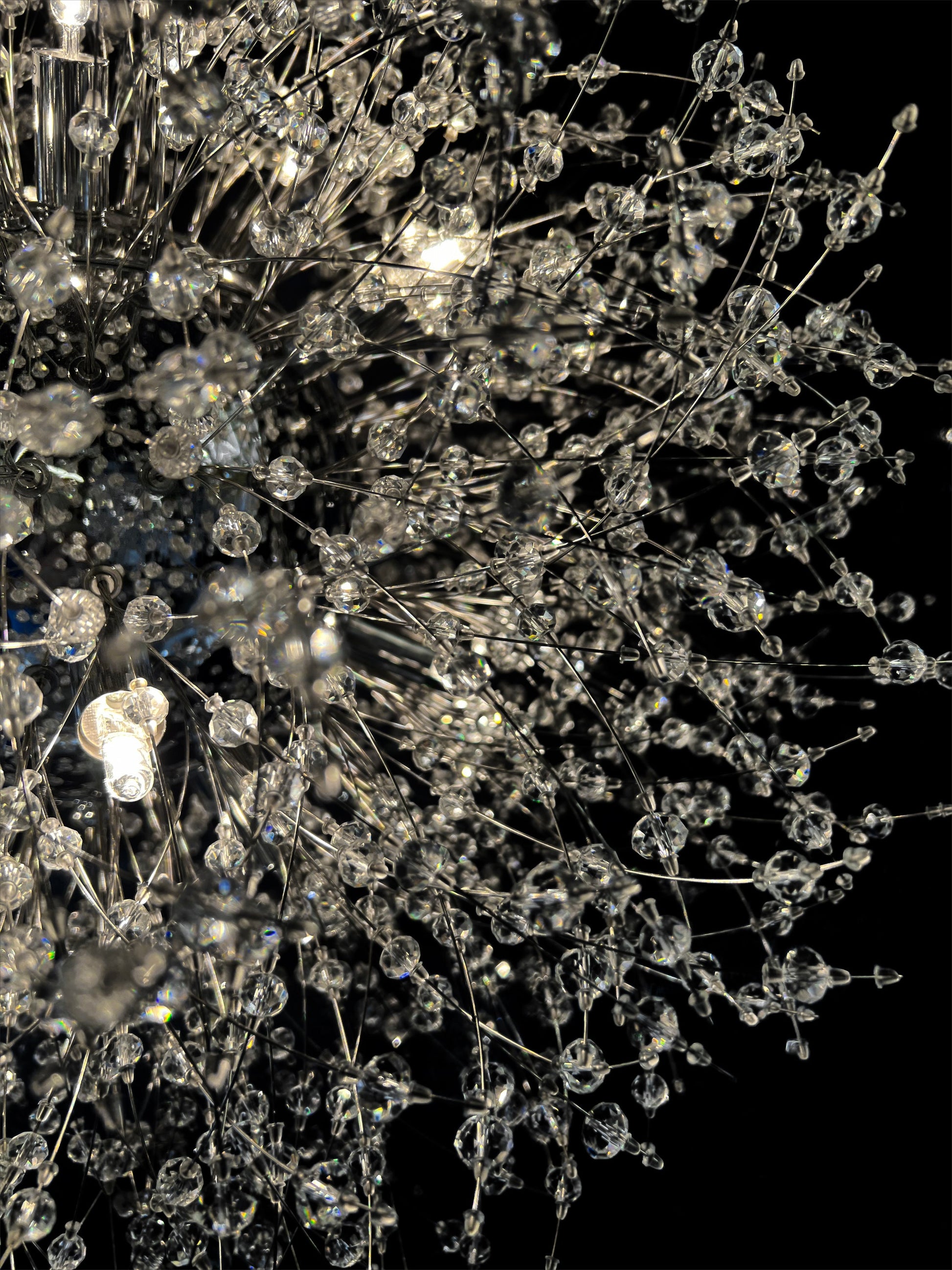  Detailed close-up of chrome starburst chandelier with sparkling crystals