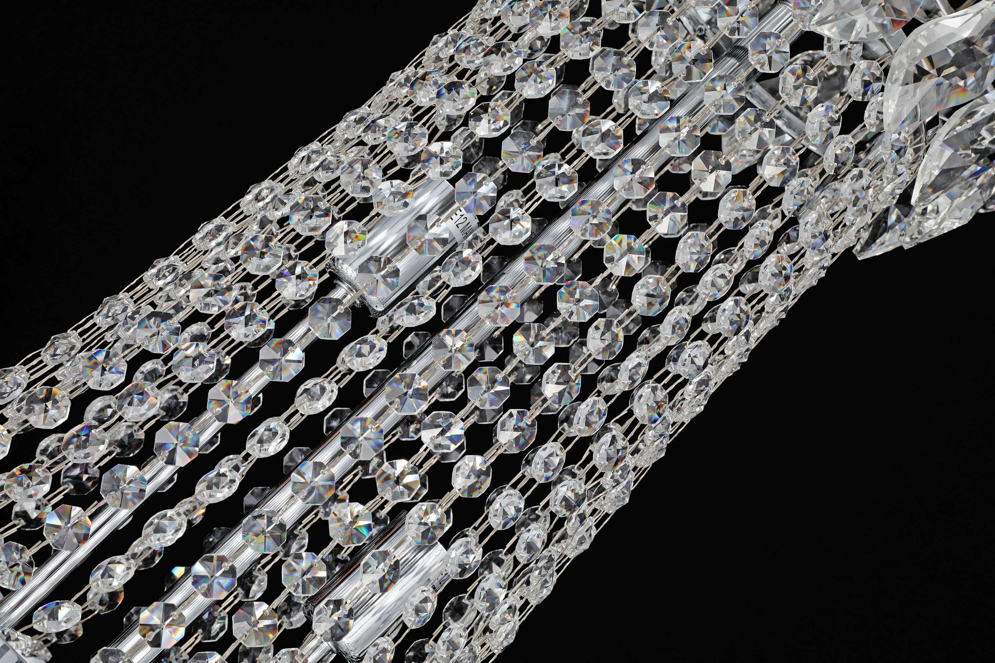 35 inch Close-up of precision-cut crystal strands and chrome accents in a luxury chandelier.
