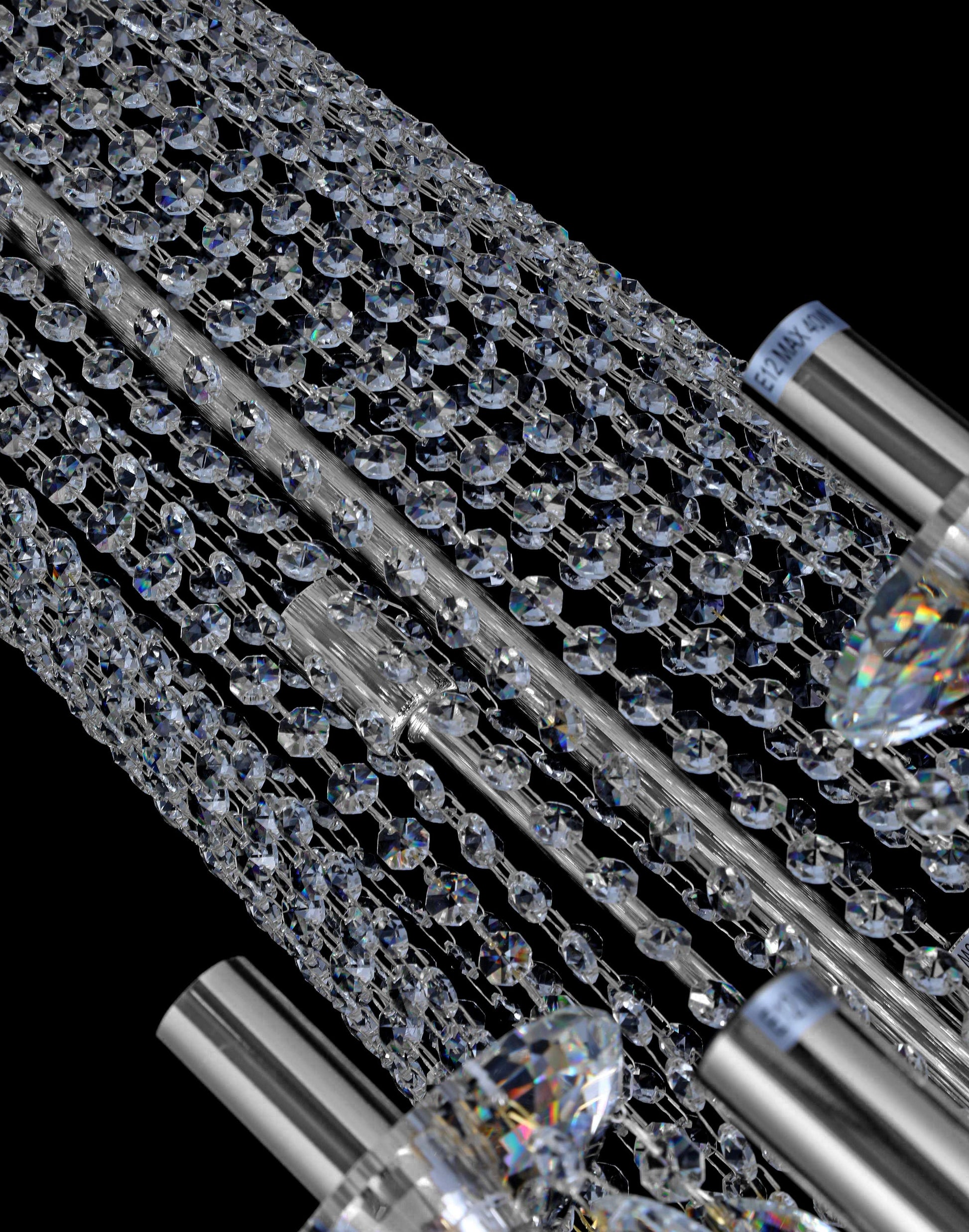 Close-up view of precision-cut crystal chains and polished chrome rods.