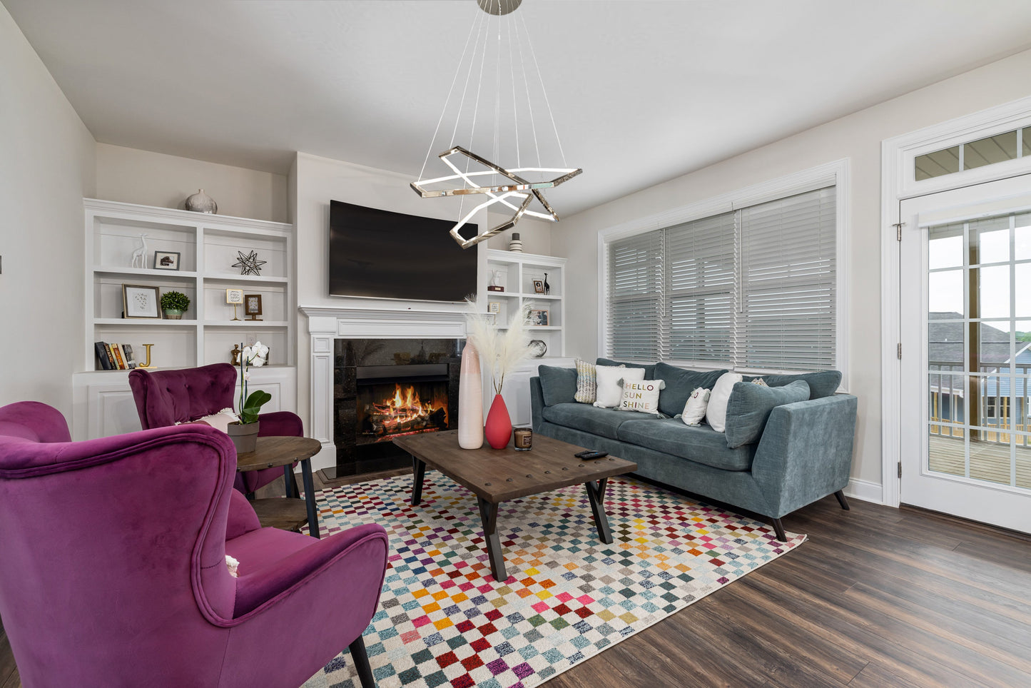 Chrome geometric LED chandelier styled in modern living room