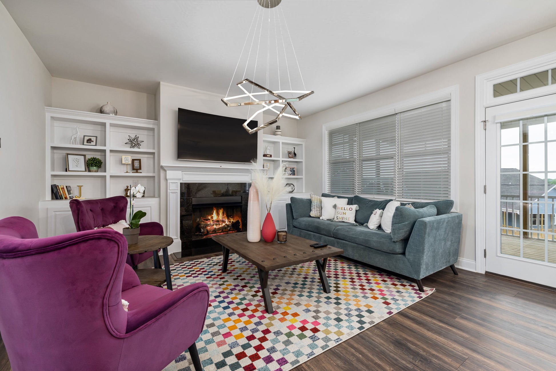 Chrome geometric LED chandelier styled in modern living room