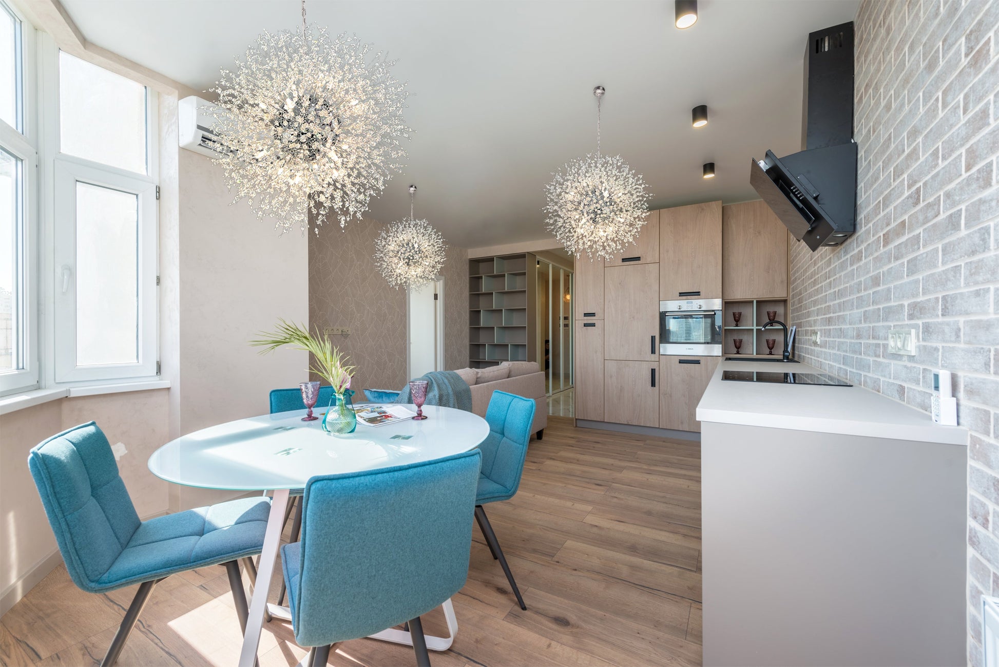 24 inch chrome starburst chandelier above contemporary dining table