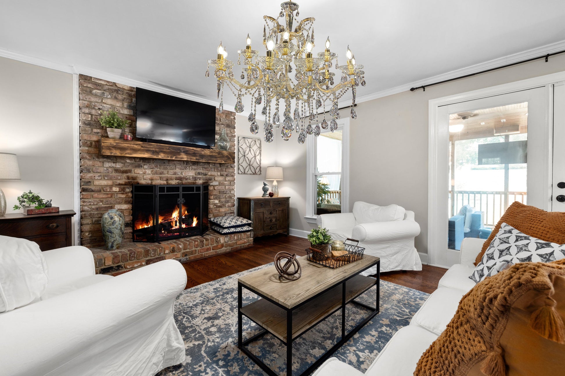 Classic Maria Theresa gold crystal 35" chandelier displayed in a bright living space.