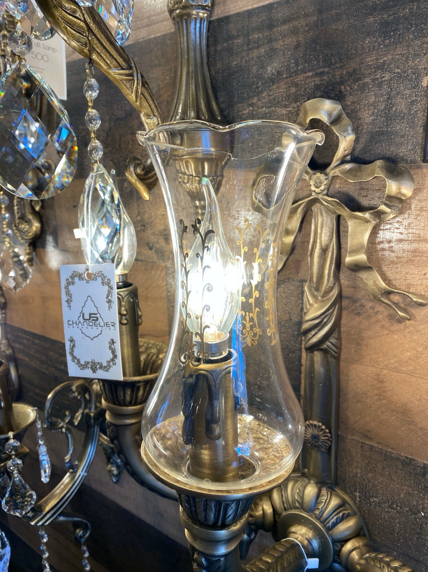 Clear glass shade with gold pattern on chandelier

