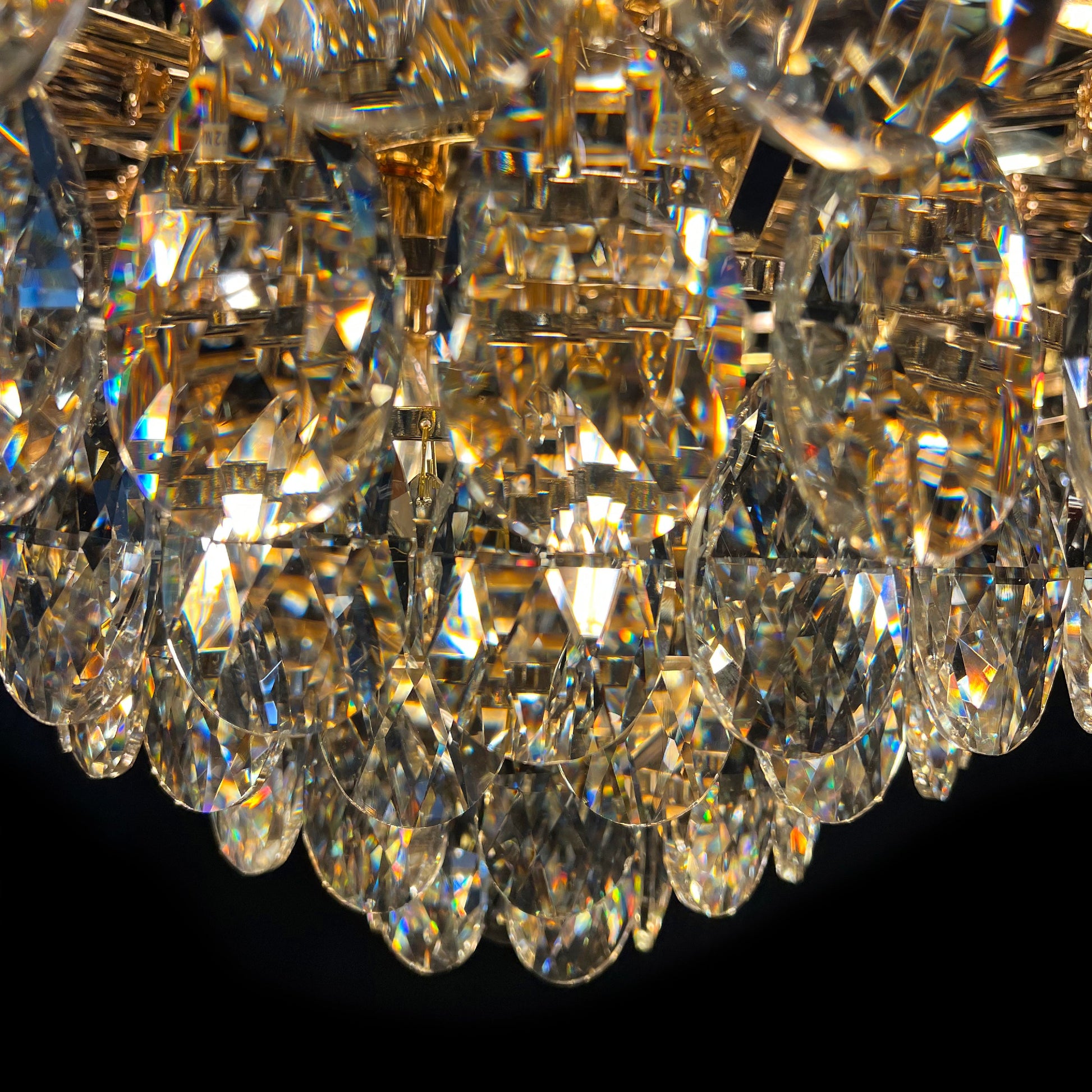 Close-up of a crystal chandelier with clear and gold elements
