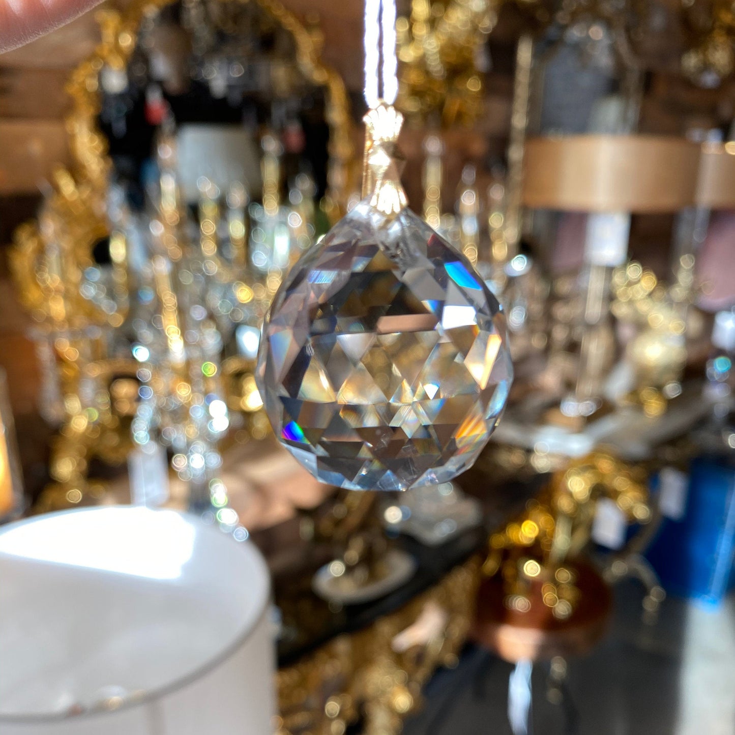 Crystal ball pendant size reference showing clarity and cut detail