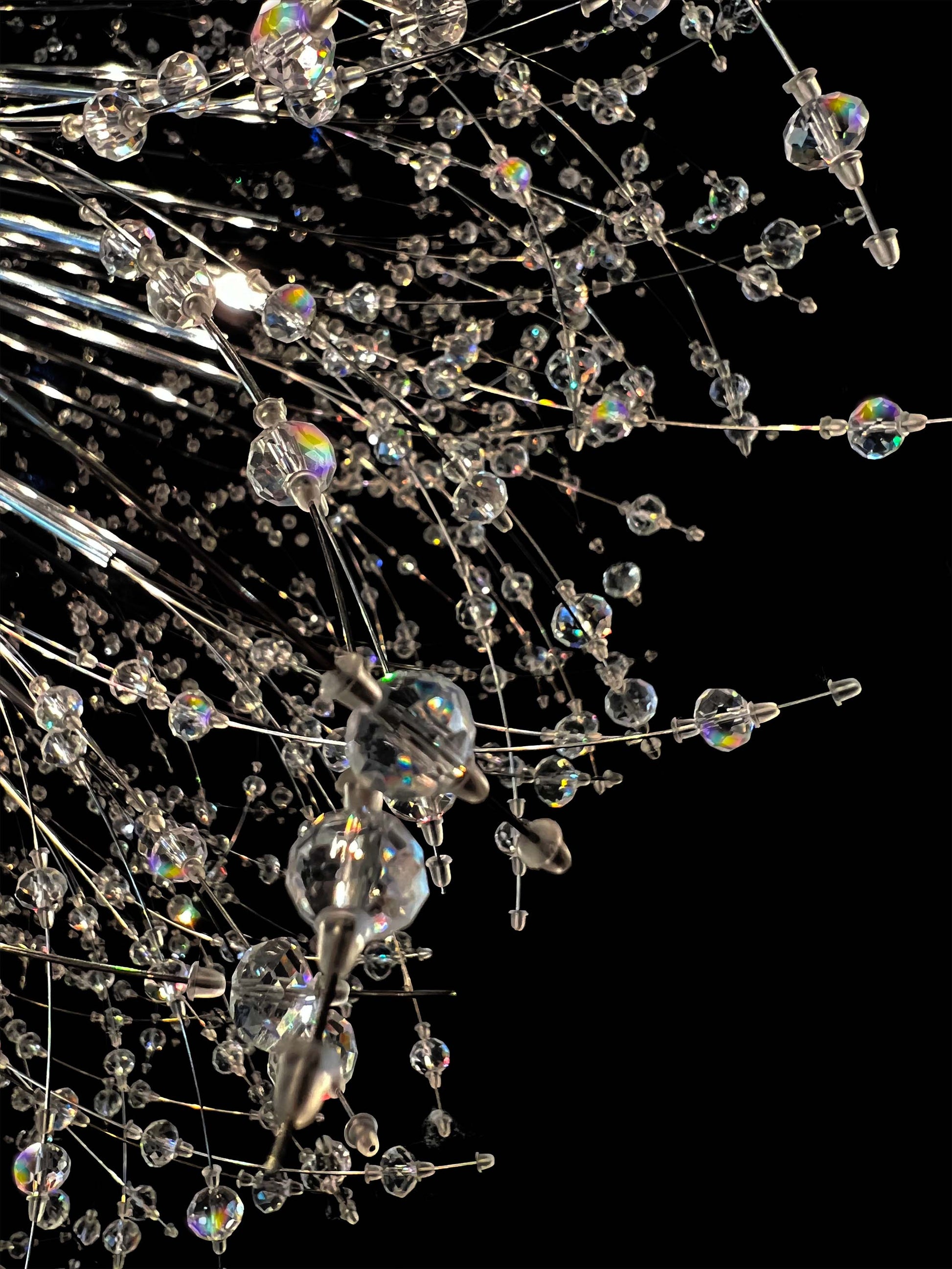 Close-up of precision-cut crystal branches with chrome finish