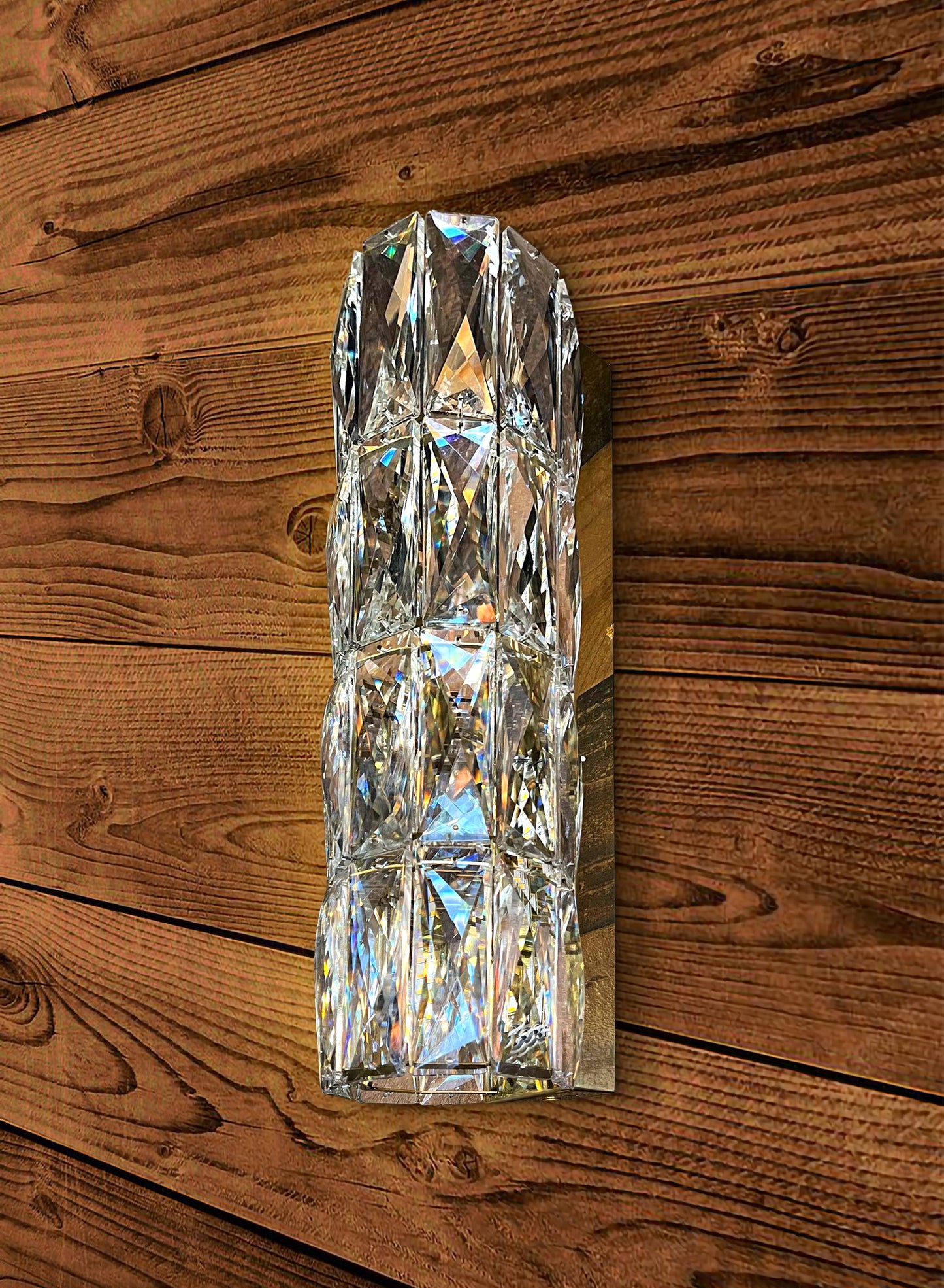 Slim crystal LED wall sconce on wood wall