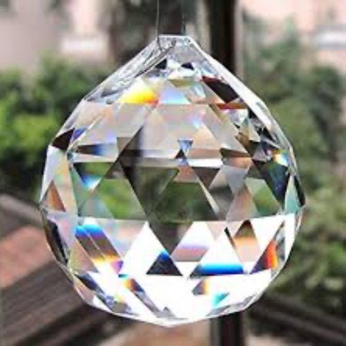 Precision cut crystal ball showing prismatic light refraction and clarity
