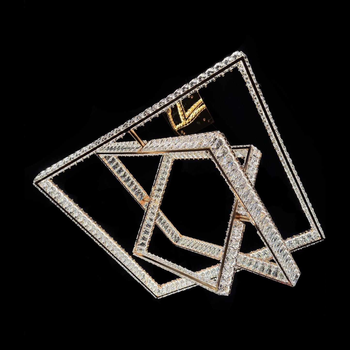 Underside view of the illuminated geometric square tiers of the modern gold chandelier.