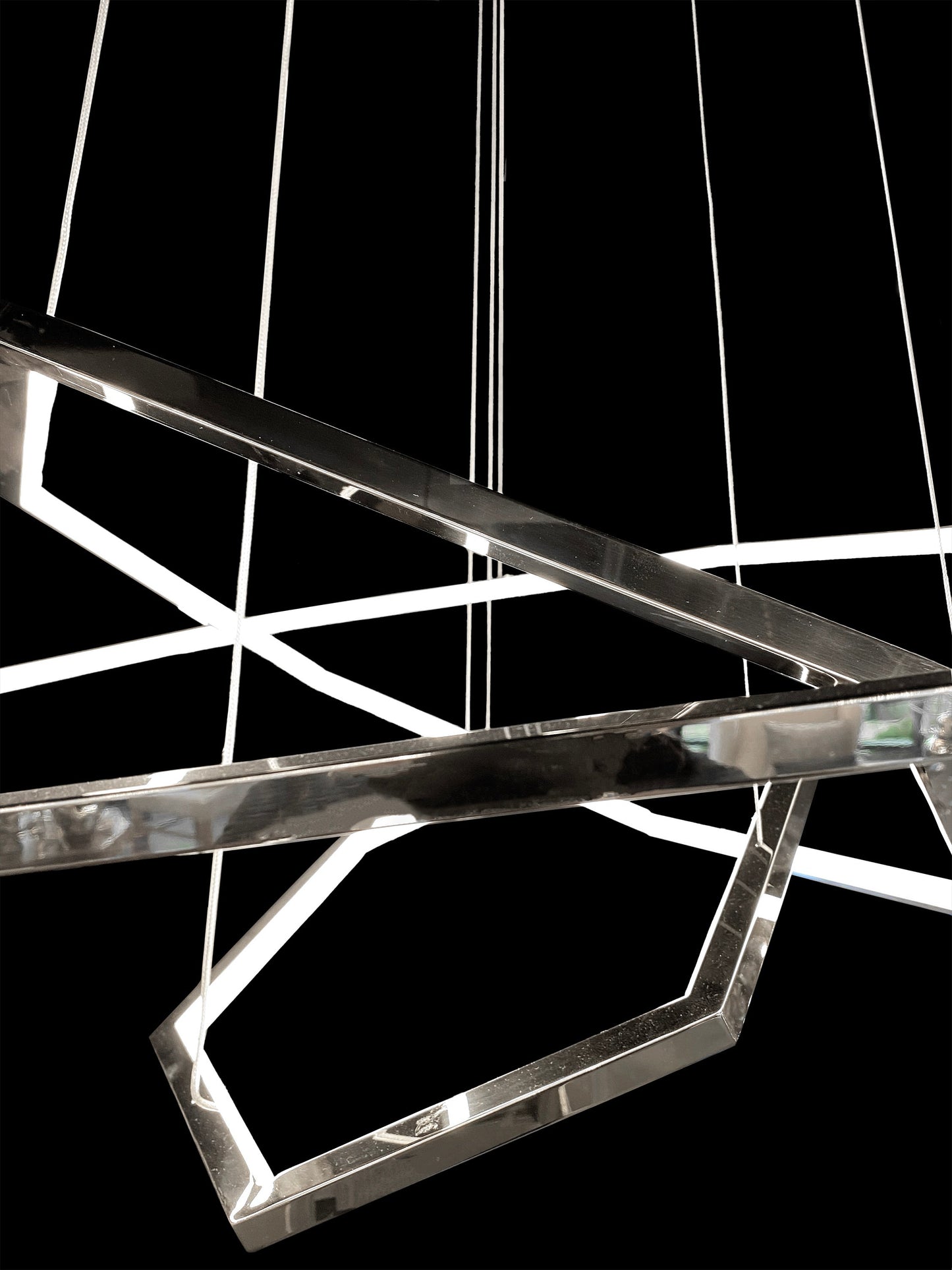 Close-up view of geometric chrome LED chandelier shape

