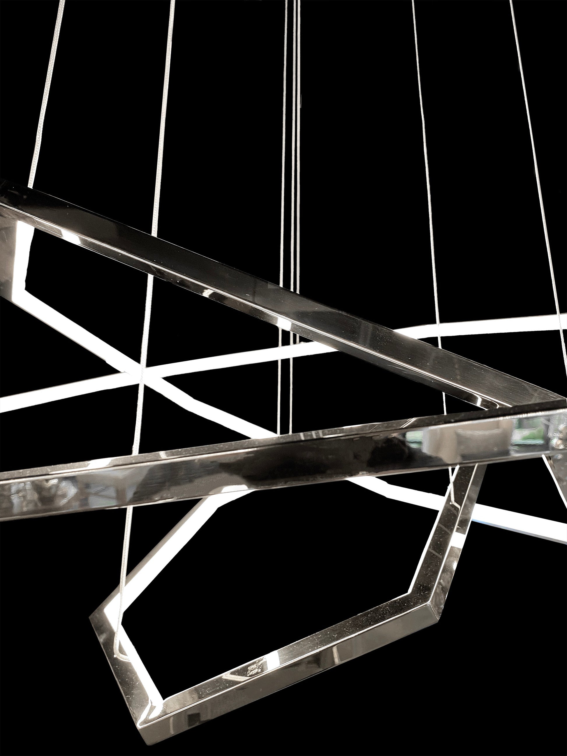Close-up view of geometric chrome LED chandelier shape
