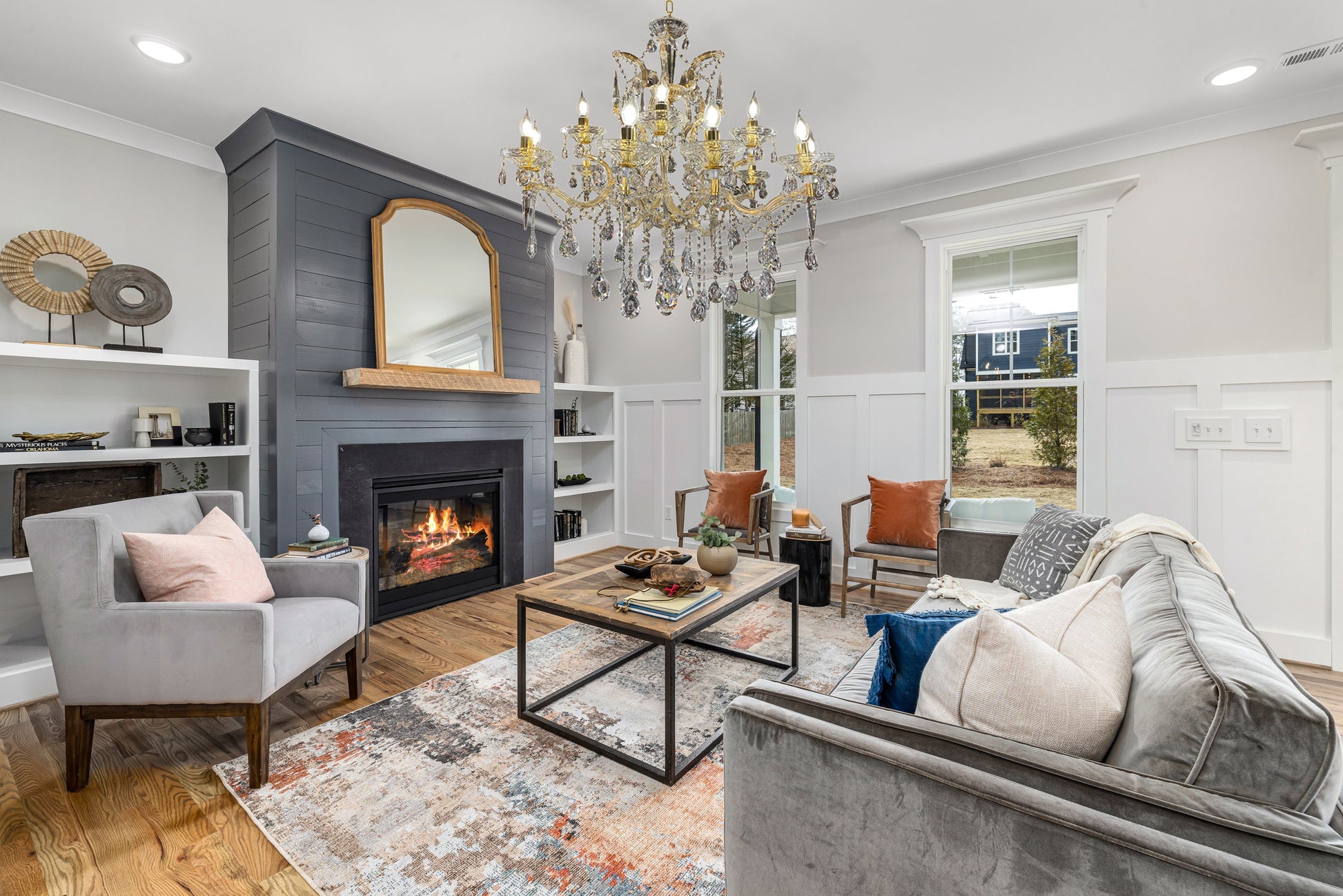 Maria Theresa 30" gold crystal chandelier styled in an elegant living room.