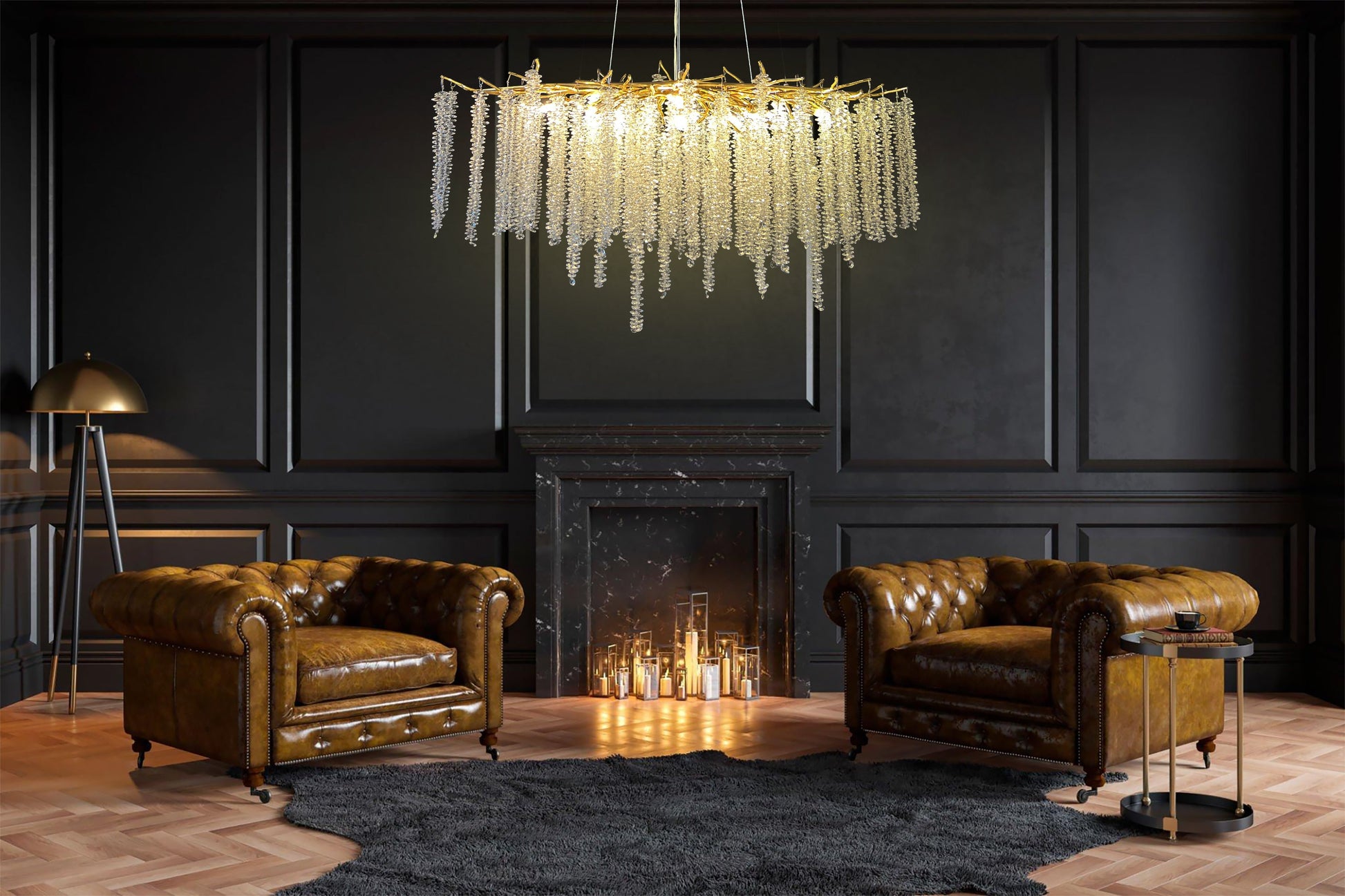 A luxurious gold crystal raindrop chandelier hanging from the ceiling, with a branch-inspired design, displayed in a room with two leather chairs and a fireplace in the background.