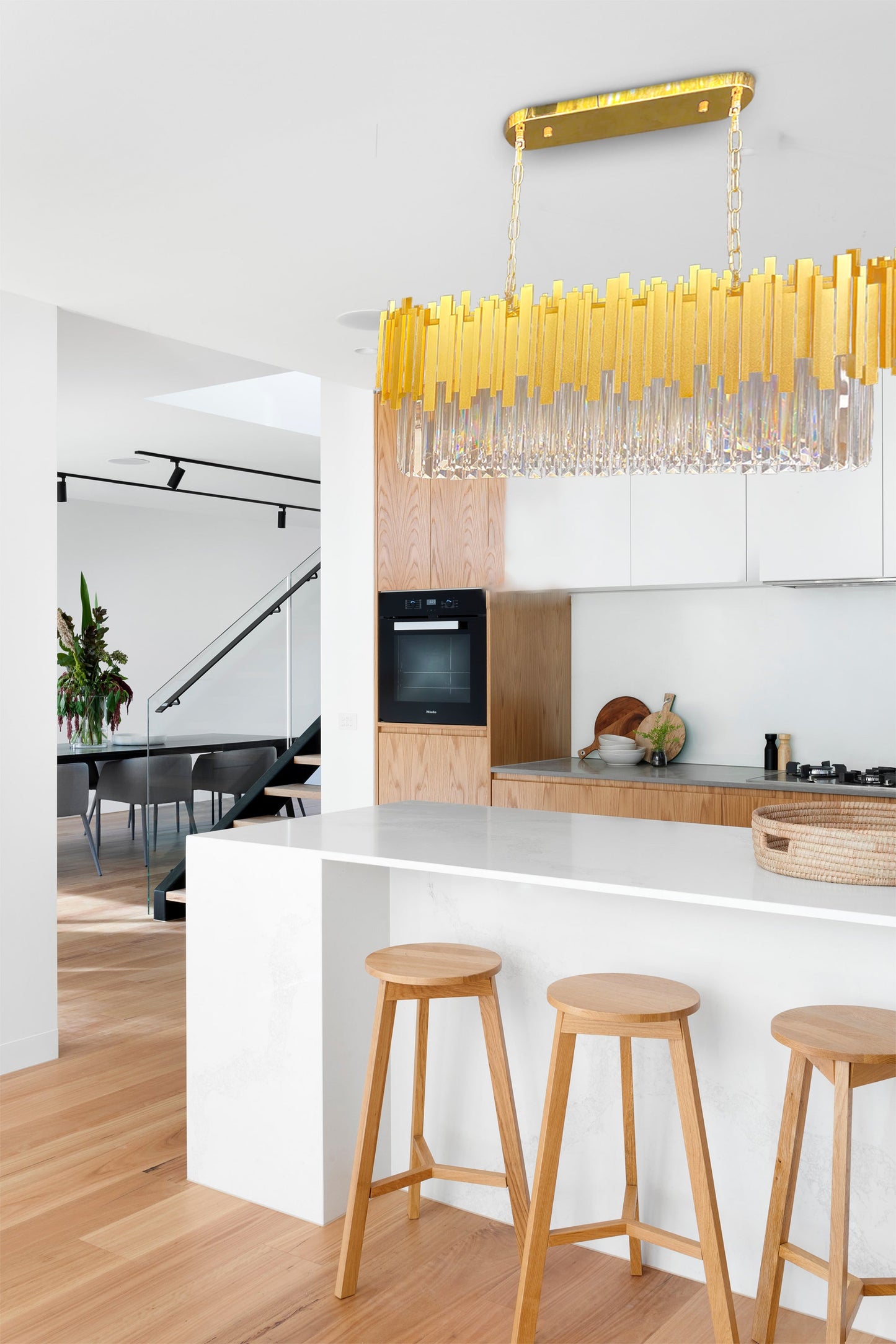 Elegant interior featuring gold linear crystal chandelier above bar area