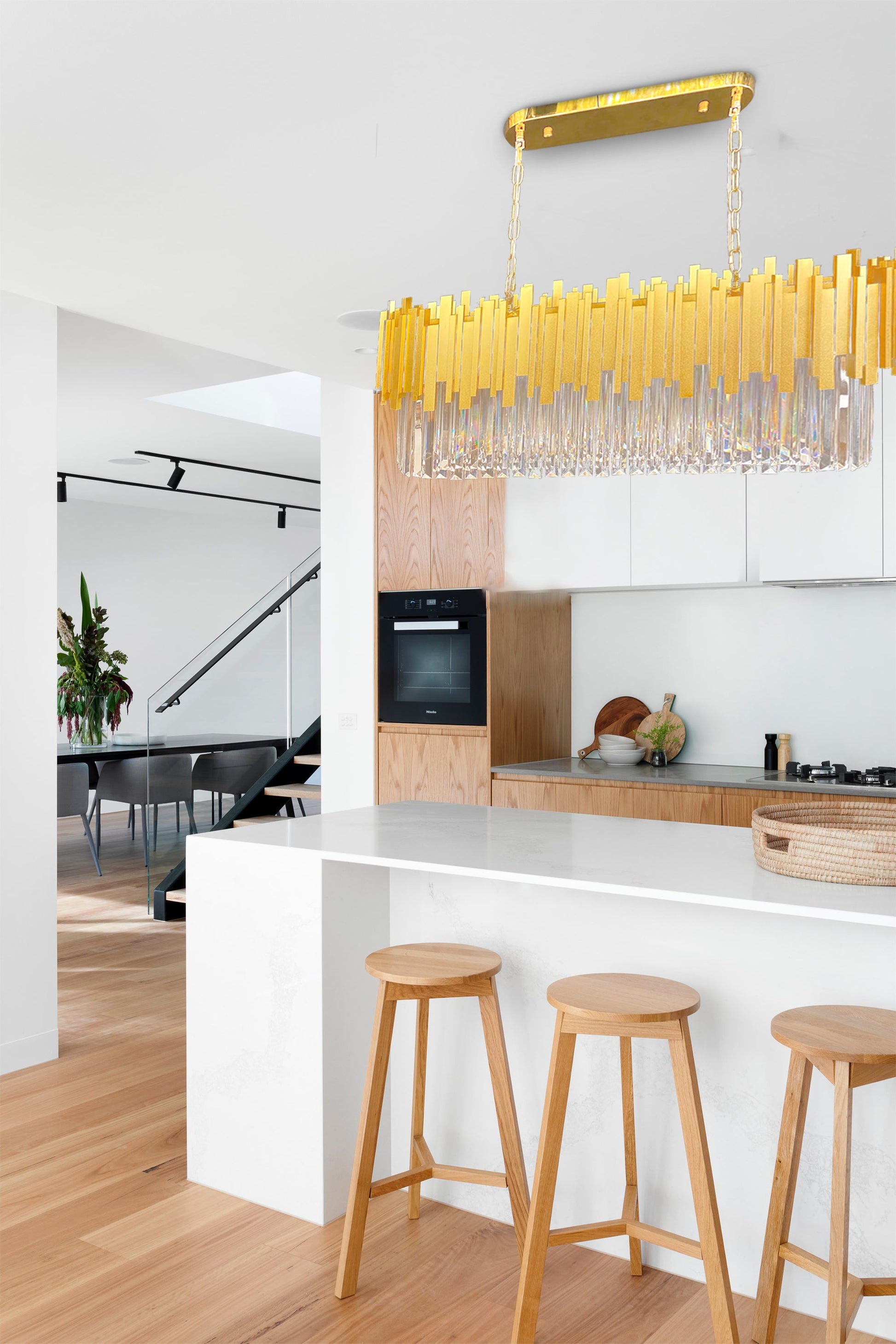 Elegant interior featuring gold linear crystal chandelier above bar area