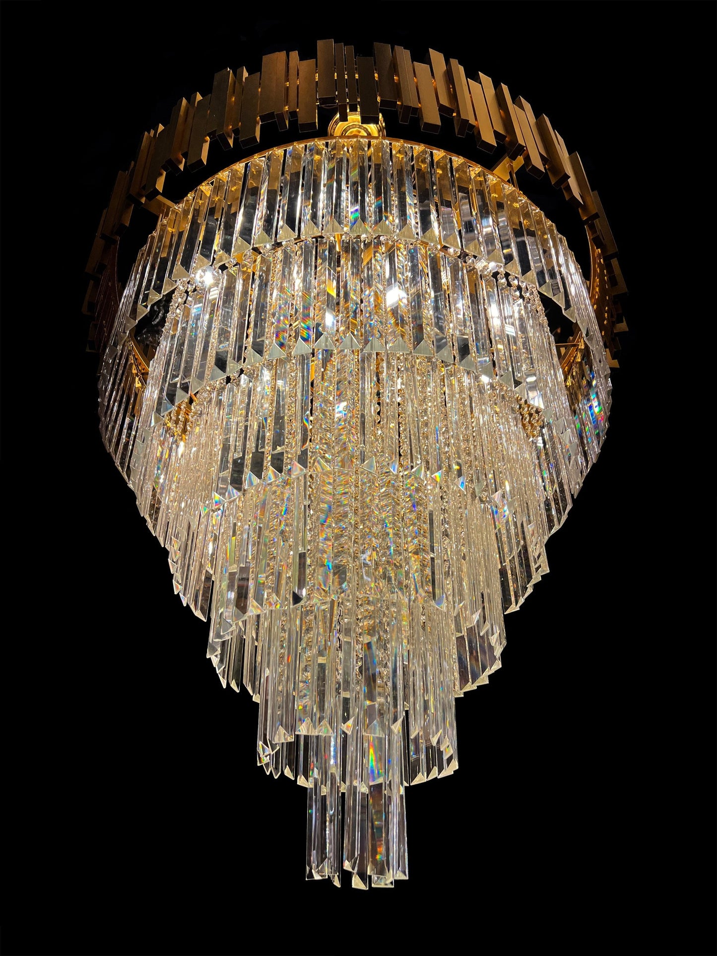 Detailed view of gold-plated rods and crystal tiers on luxury chandelier