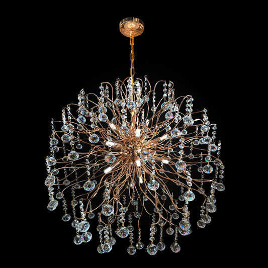 A gold-finished metal frame chandelier with cascading crystal droplets and illuminated by halogen bulbs.