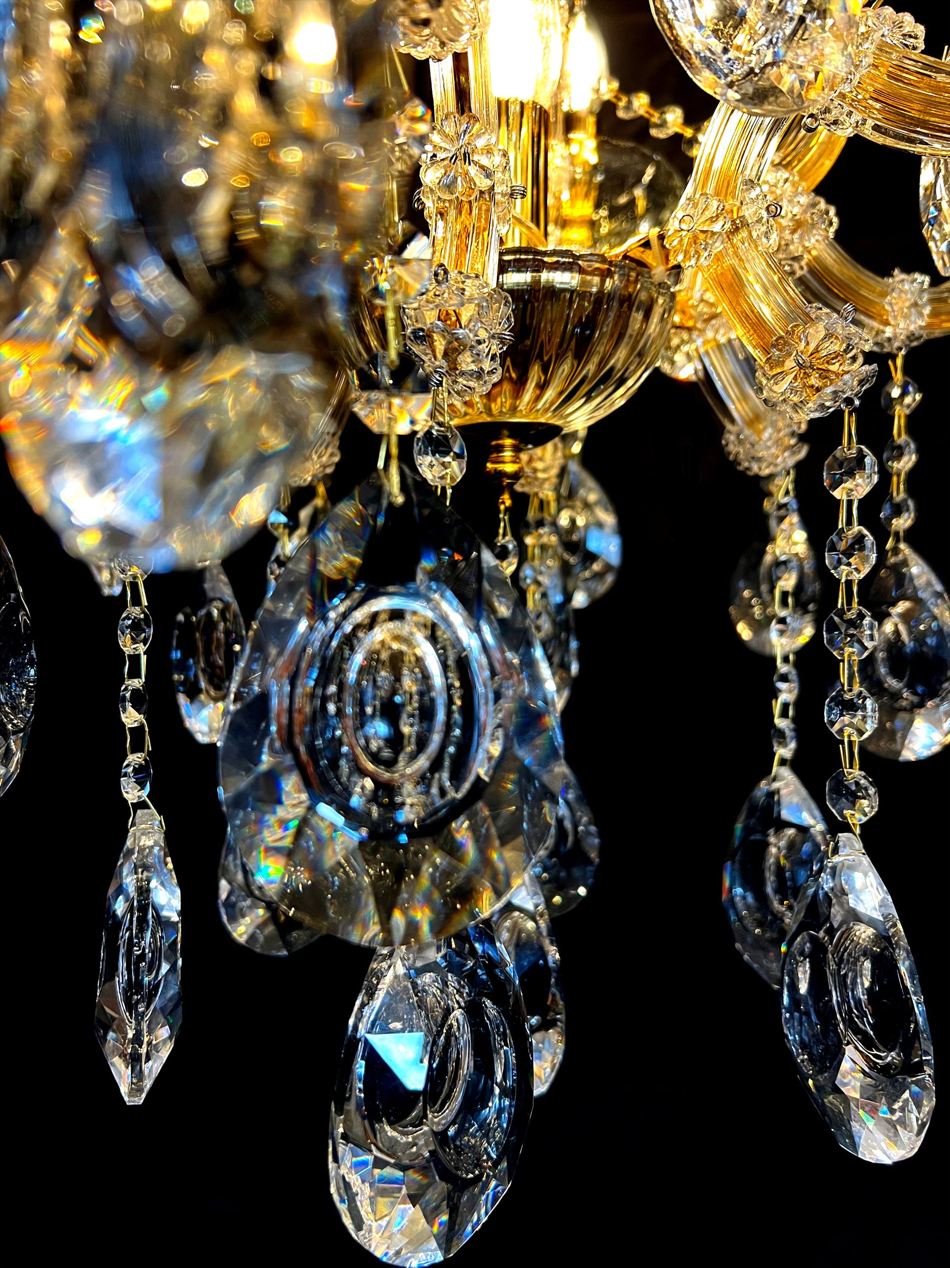 Close-up of 30% full-lead teardrop crystals on gold Maria Theresa chandelier.