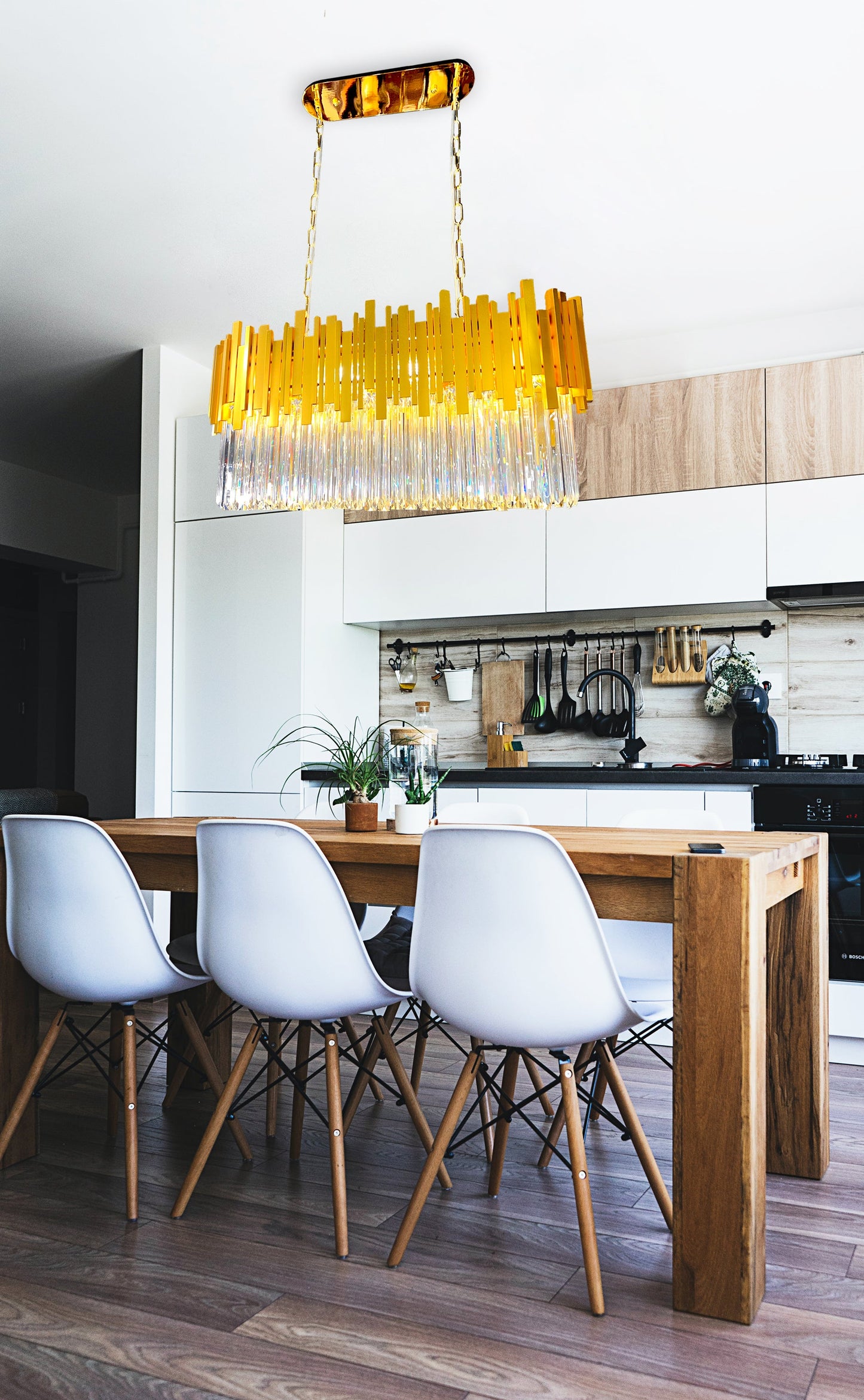 Gold linear crystal chandelier styled above modern kitchen island