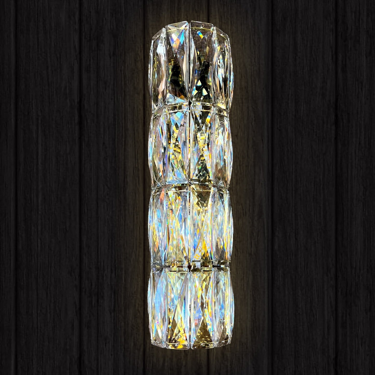 Gold slim crystal LED wall sconce on dark wall