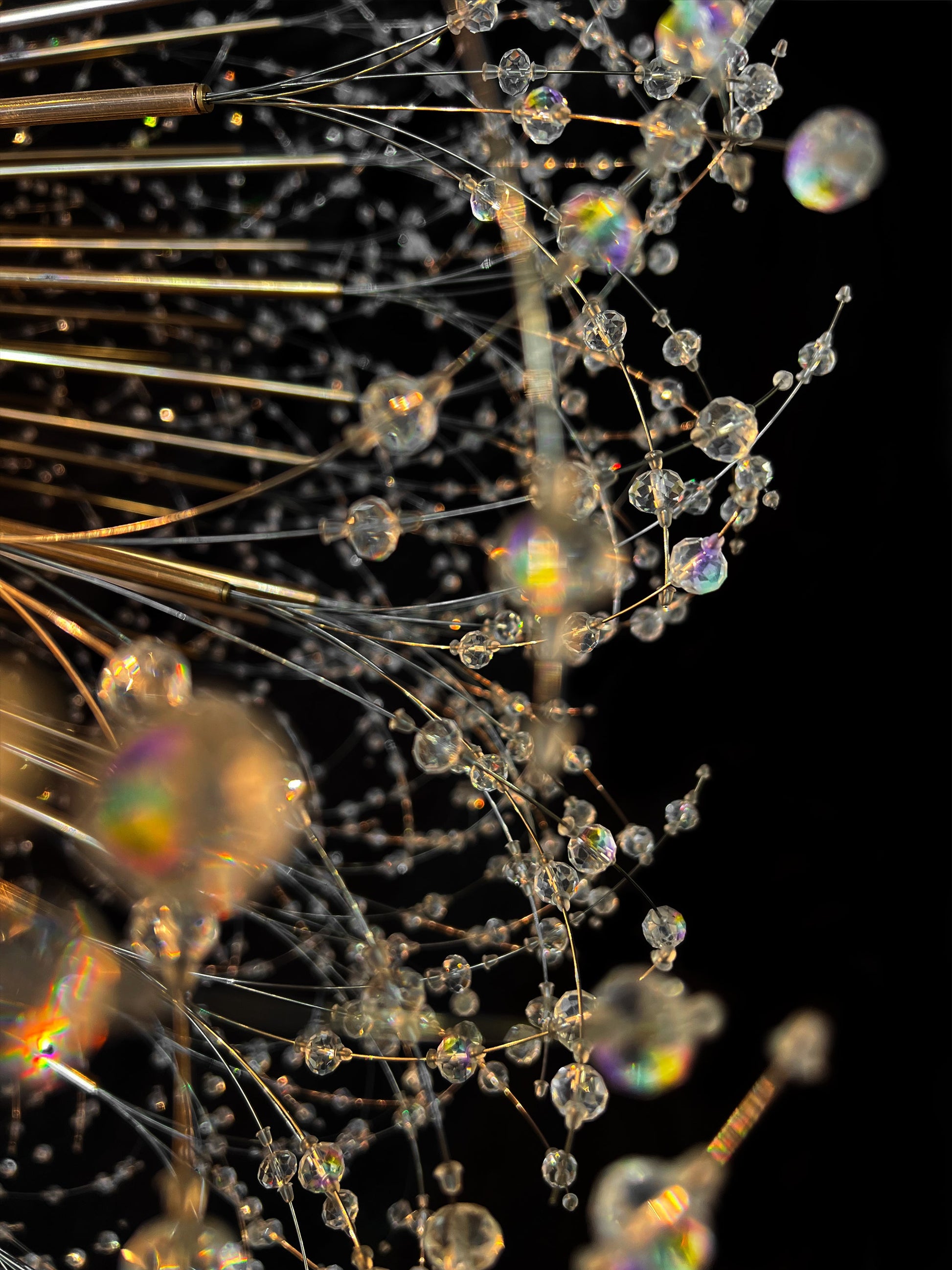 Handcrafted crystal branches with gold finish reflecting warm light